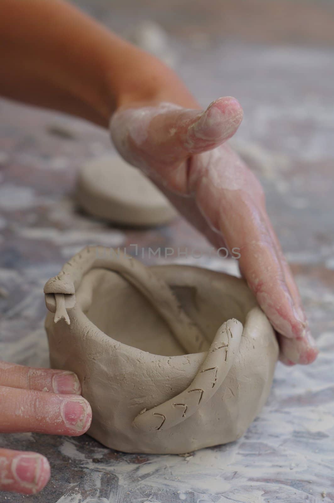 children learning to make pottery out side