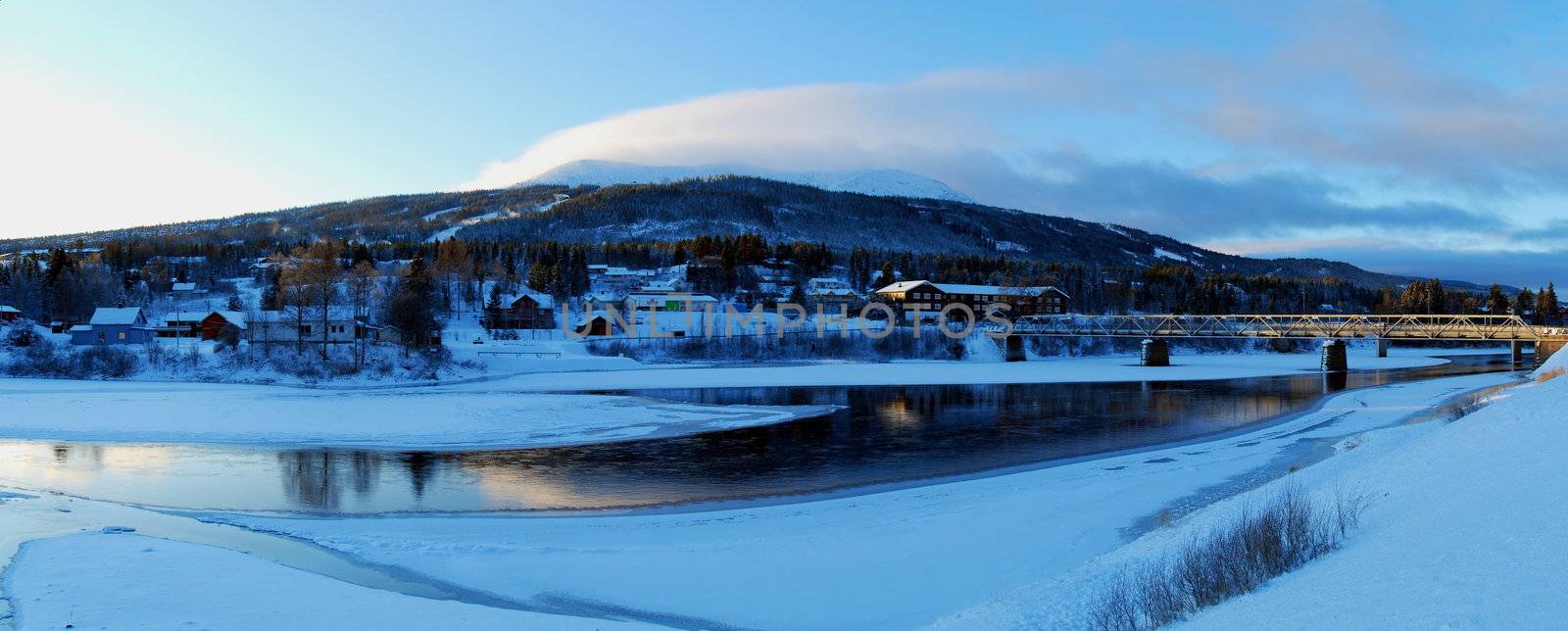 Evening view the bridge across the river and mountain. Winter in Trysil.