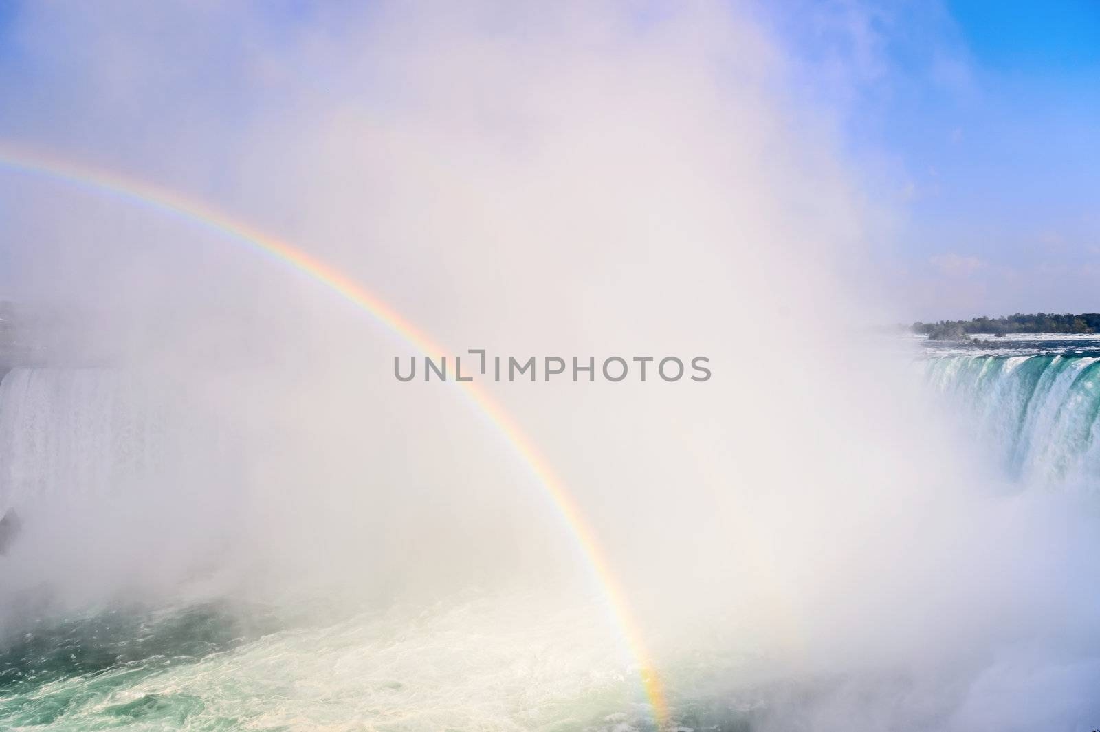 Rainbow rises from the mist at Horseshoe, Niagara Falls, Ontario, Canada