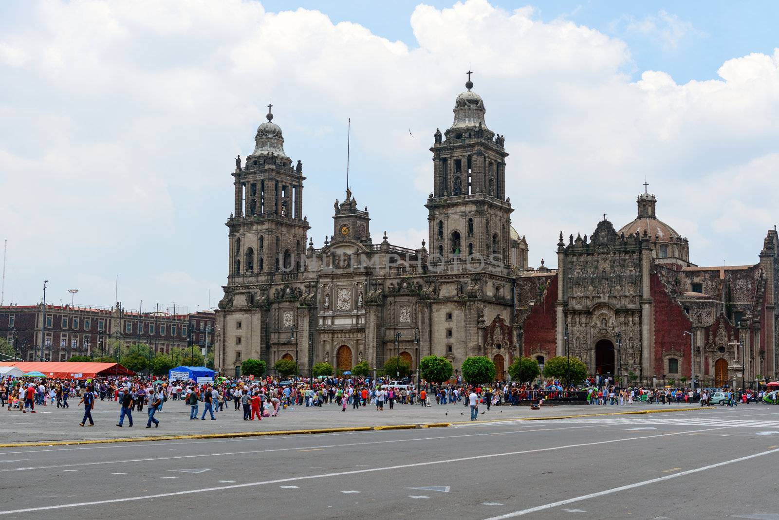 The Metropolitan Cathedral of the Assumption of Mary of Mexico City is the oldest and largest cathedral in the Americas and seat of the Roman Catholic Archdiocese of Mexico. It is situated atop the former Aztec sacred precinct near the Templo Mayor on the northern side of the Plaza de la Constitución in downtown Mexico City. The cathedral was built in sections from 1573 to 1813 around the original church that was constructed soon after the Spanish conquest of Tenochtitlán, eventually replacing it entirely. Spanish architect Claudio de Arciniega planned the construction, drawing inspiration from Gothic cathedrals in Spain.