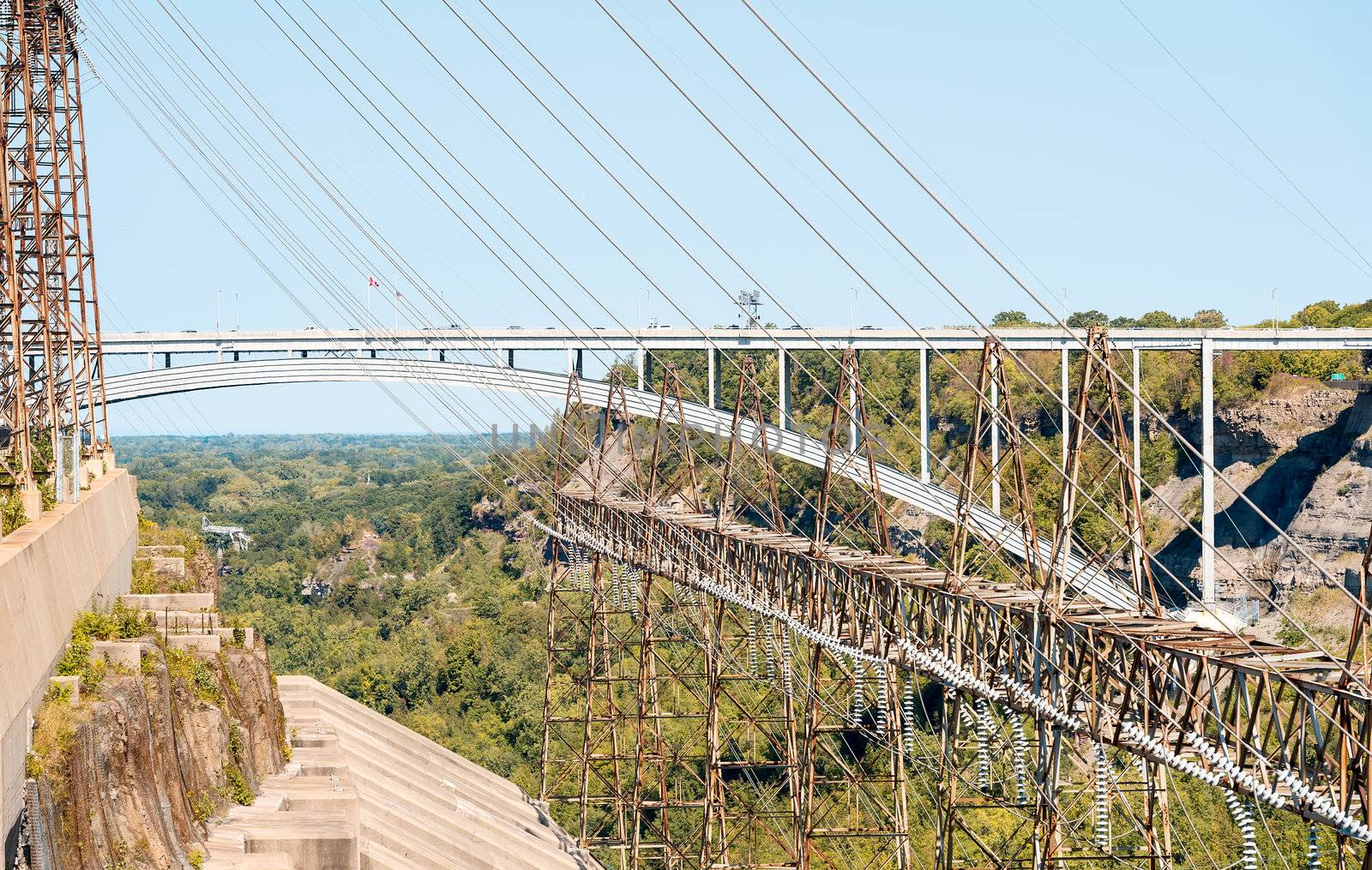 Niagara Power plant lines with the US/Canadian border bridge in the background. Adam Beck Power Plant by the Queenston Lewiston Bridge