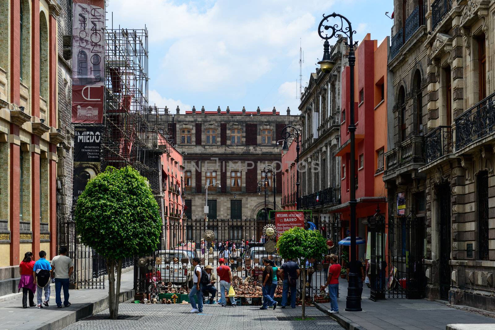 Busy street in historic part of Mexico city. Colonial buildings on both sides.