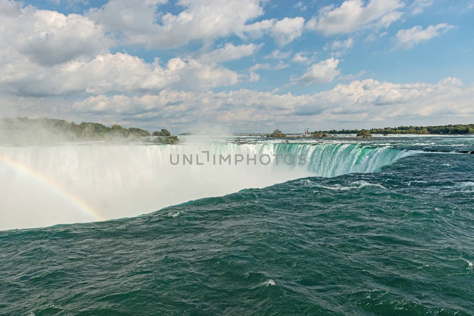 Rainbow rises from the mist at Horseshoe, Niagara Falls, Ontario, Canada