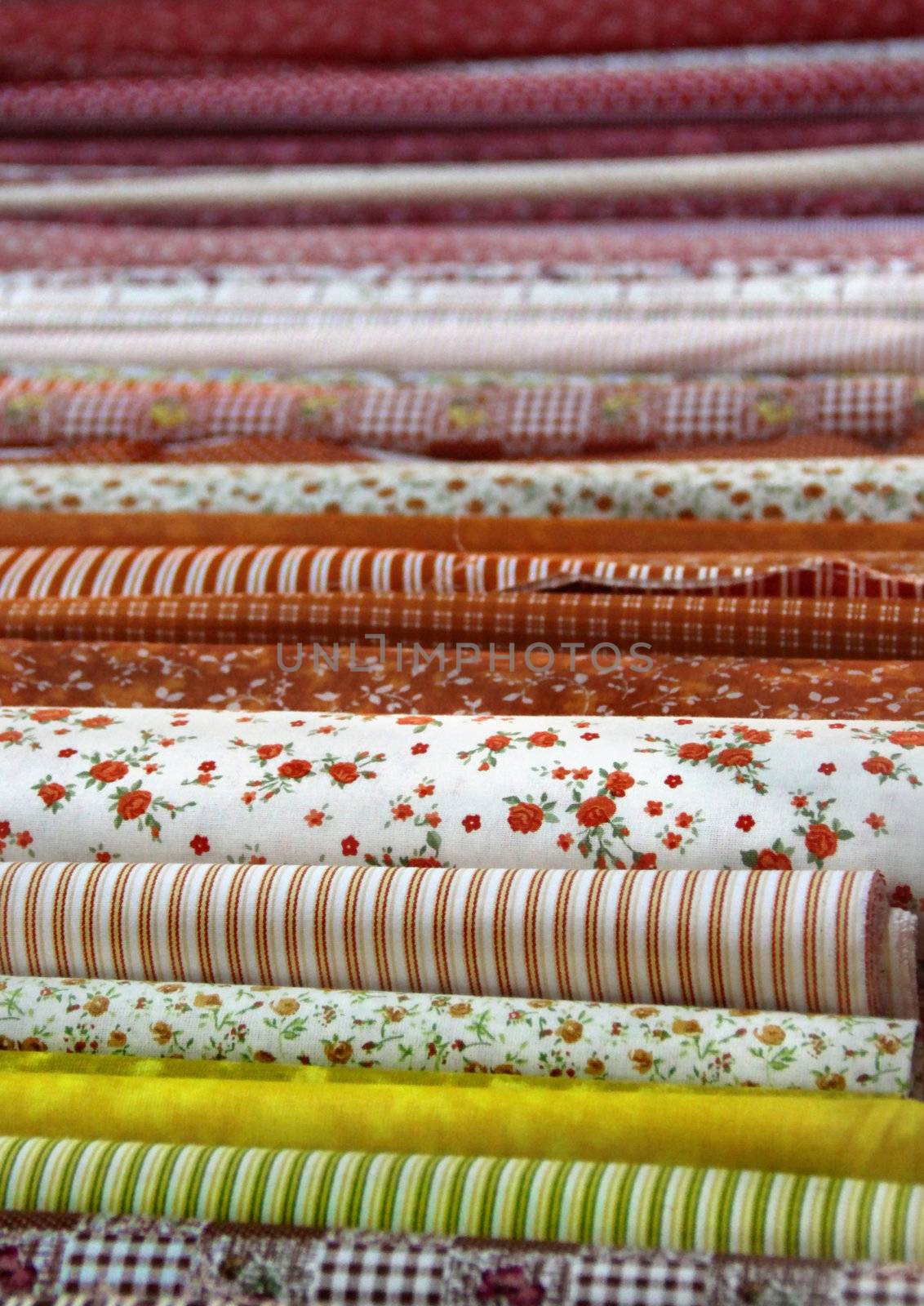 Big assortment of fabrics in the textile store 