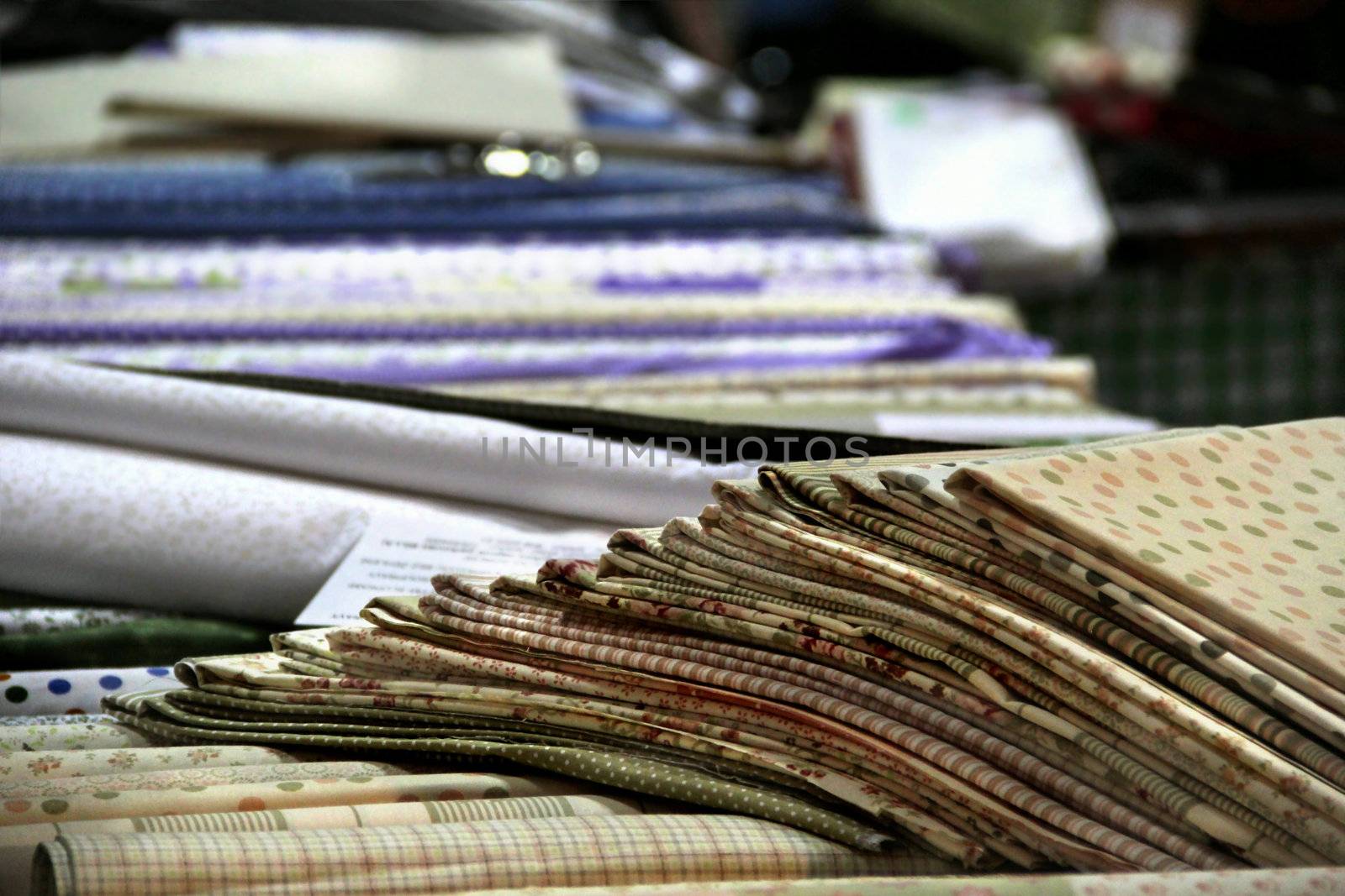 Big assortment of fabrics in the textile store 