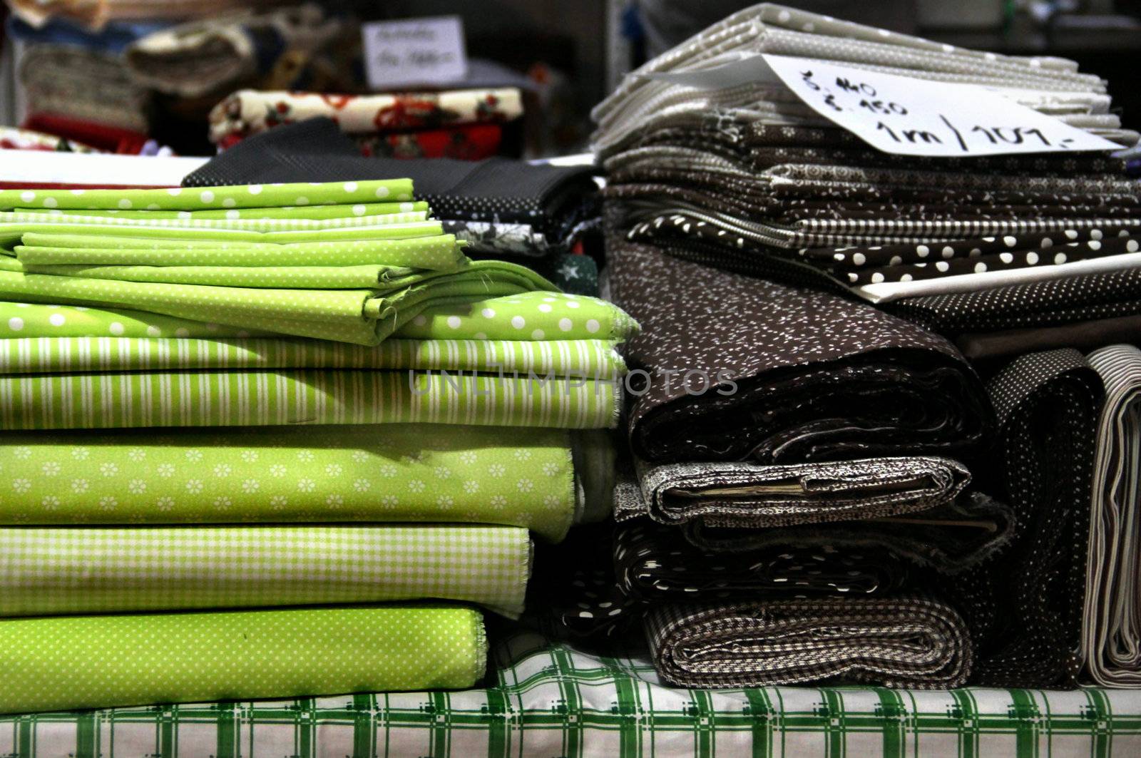 Big assortment of fabrics in the textile store 