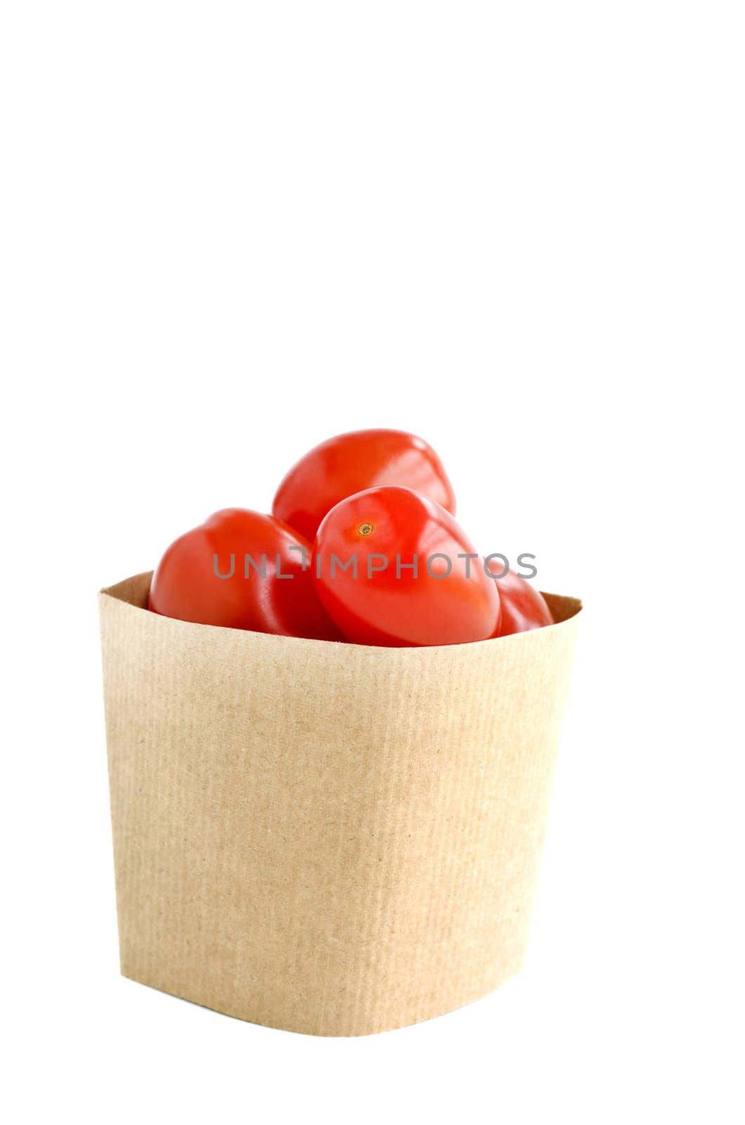 Tomatos in paper bag isolated on white background