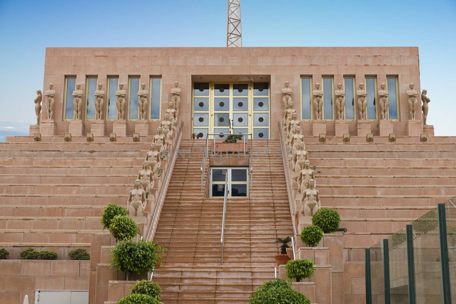 building with statute of naked woman at the stairs