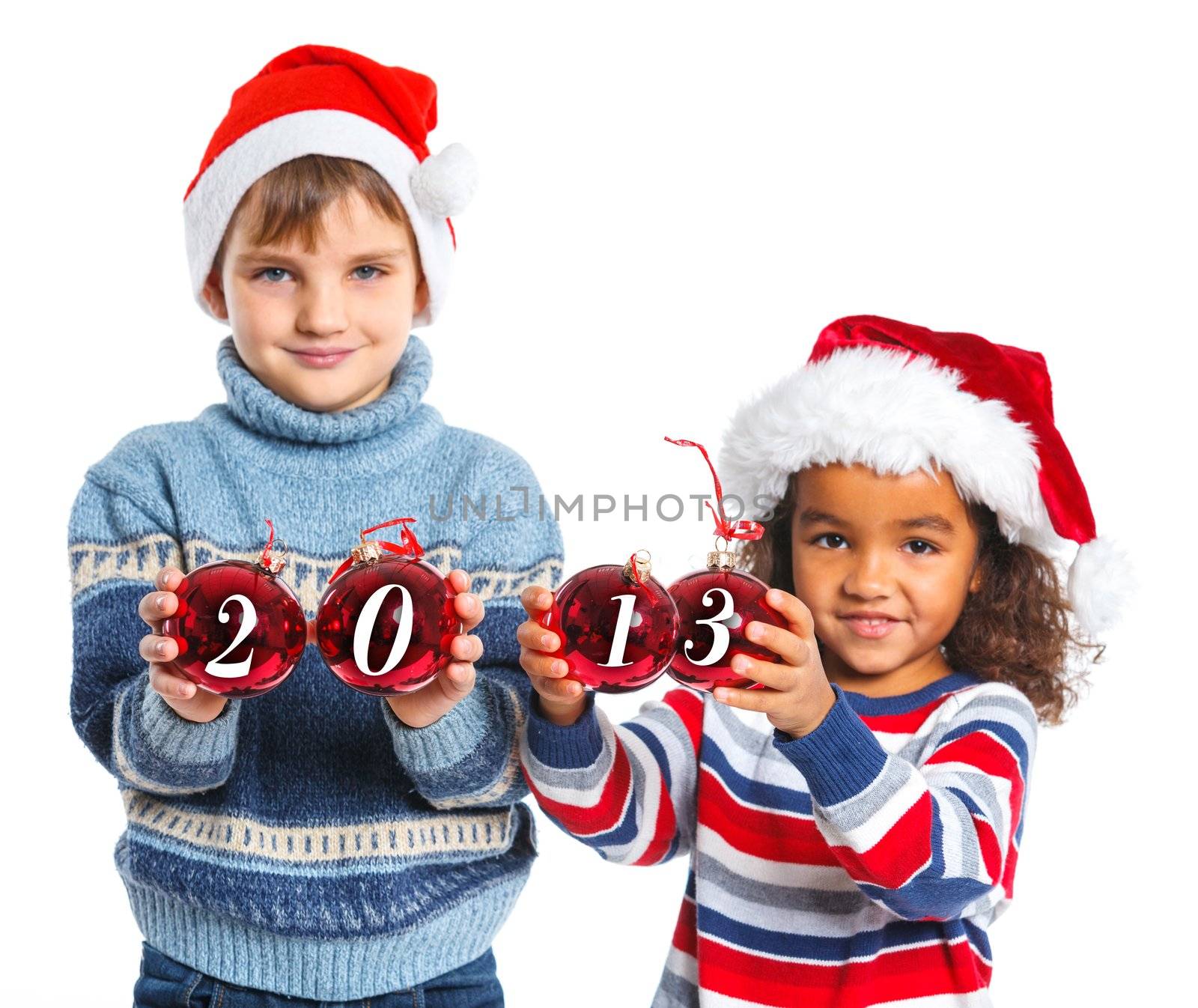 Kids in Santa's hat holding a christmas ball with 2013 against a white background. Focus on the ball