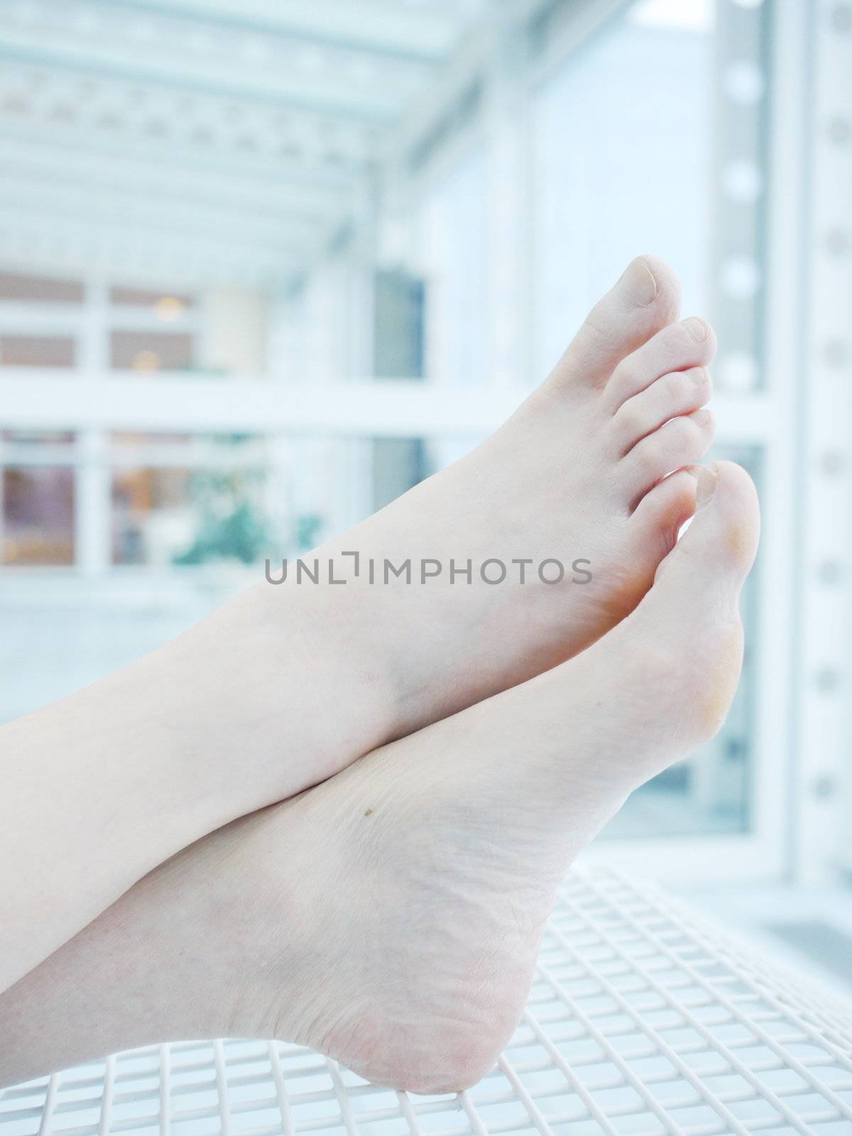 woman holding sore knee, isolated on white