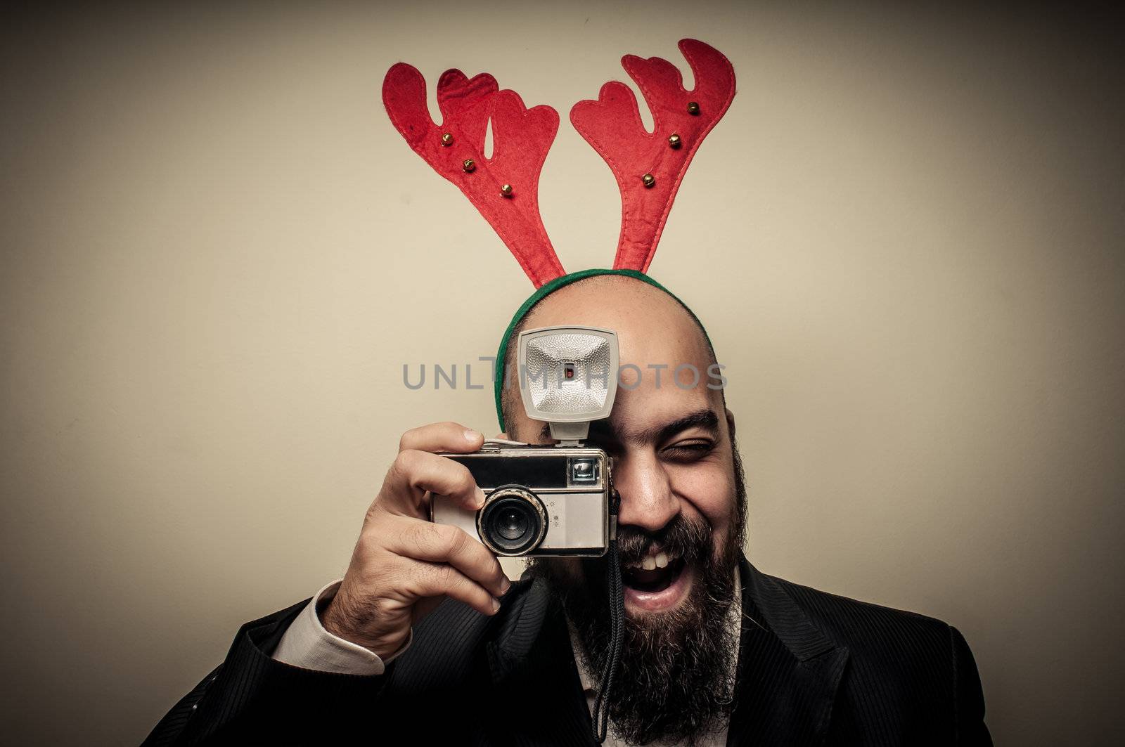 christmas bearded man holding old camera by peus