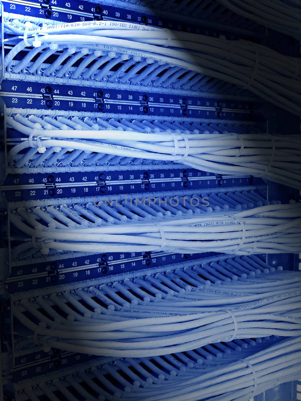 kind of wiring closet patch panels with 6-th category in the background