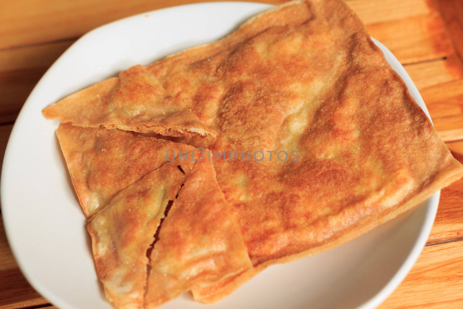 southern flat bread or crispy roti on white plate
