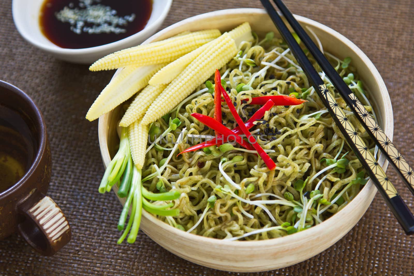 Spinach noodle salad with baby corn,spring onion and soysauce and sesame dressing
