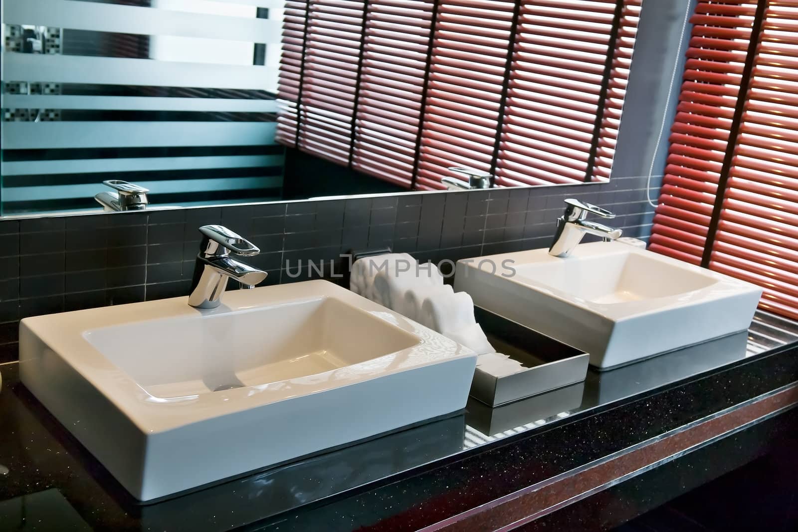 two square sink in the bathroom with a window and shutters