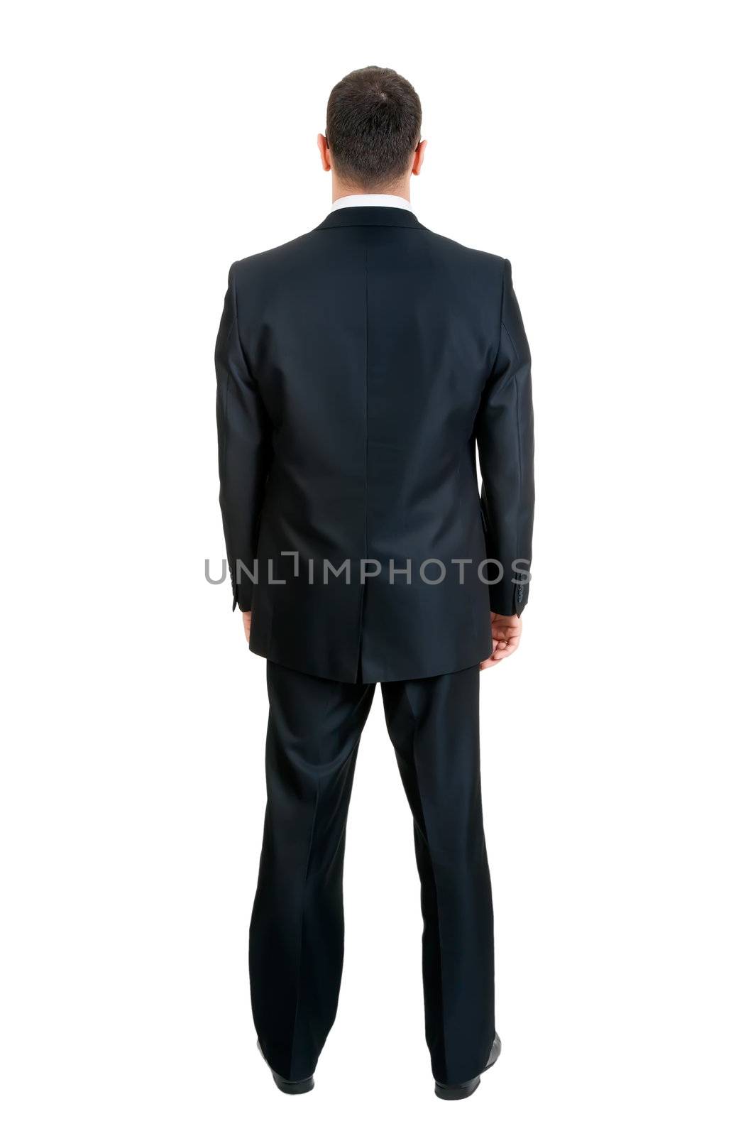 Businessman standing with his back to the studio, isolated on white