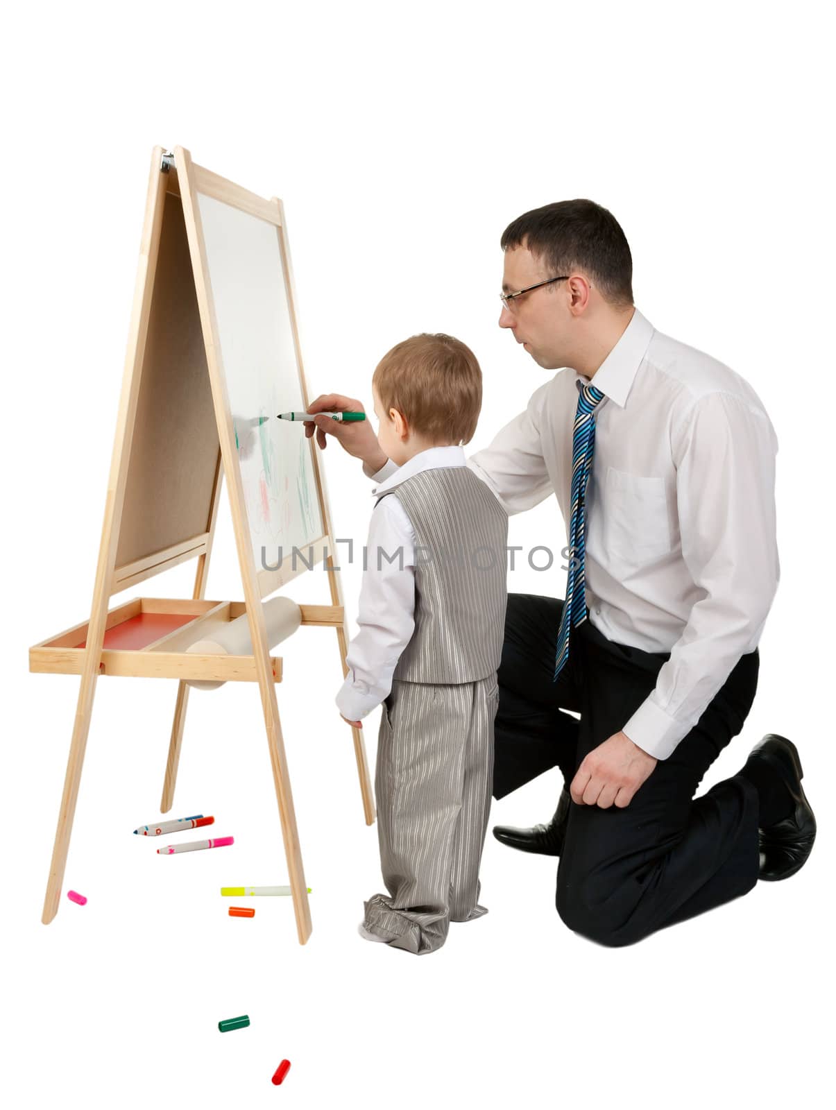Businessman teaches his son to paint on an easel, isolate on white