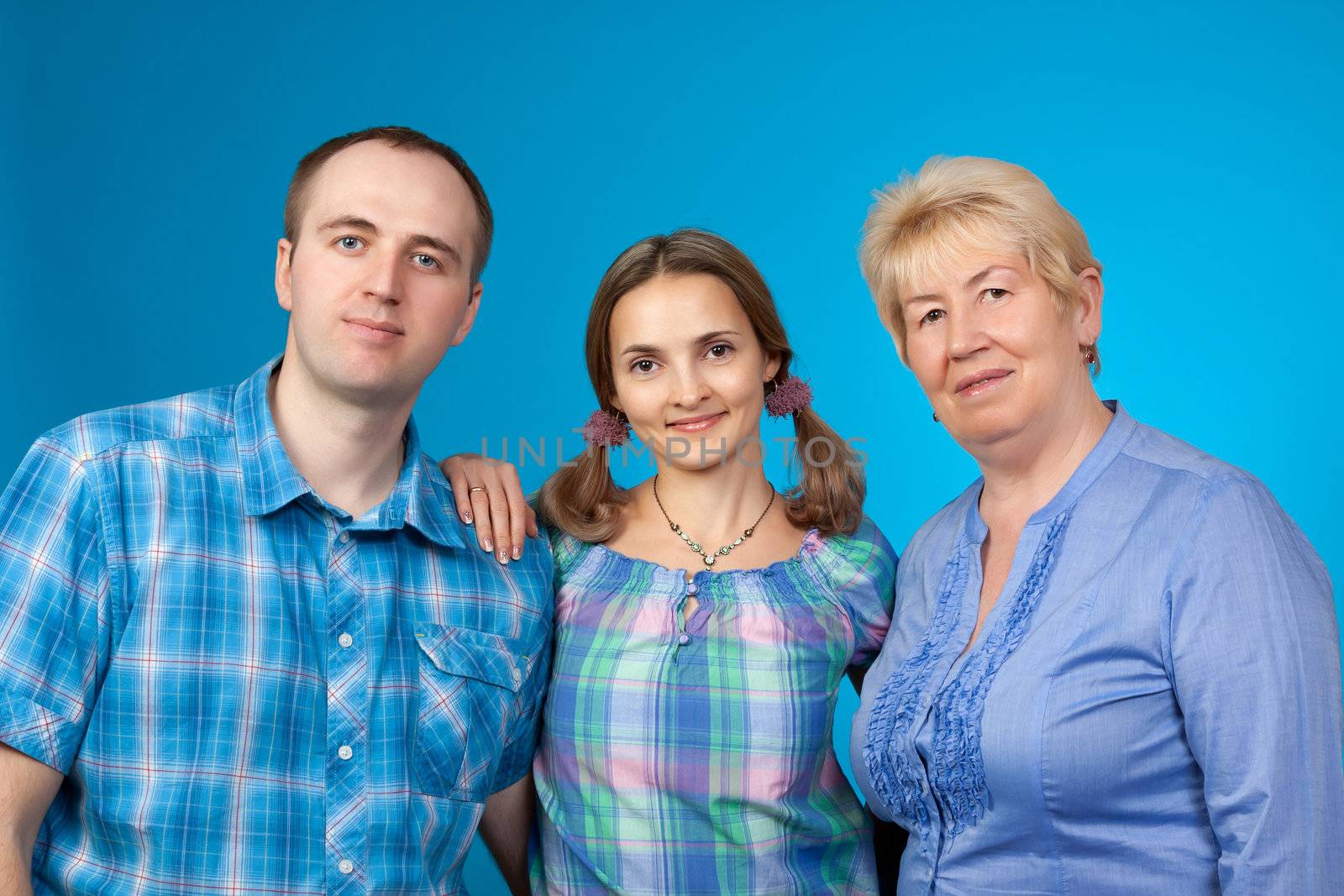 Happy family in the studio on blue background