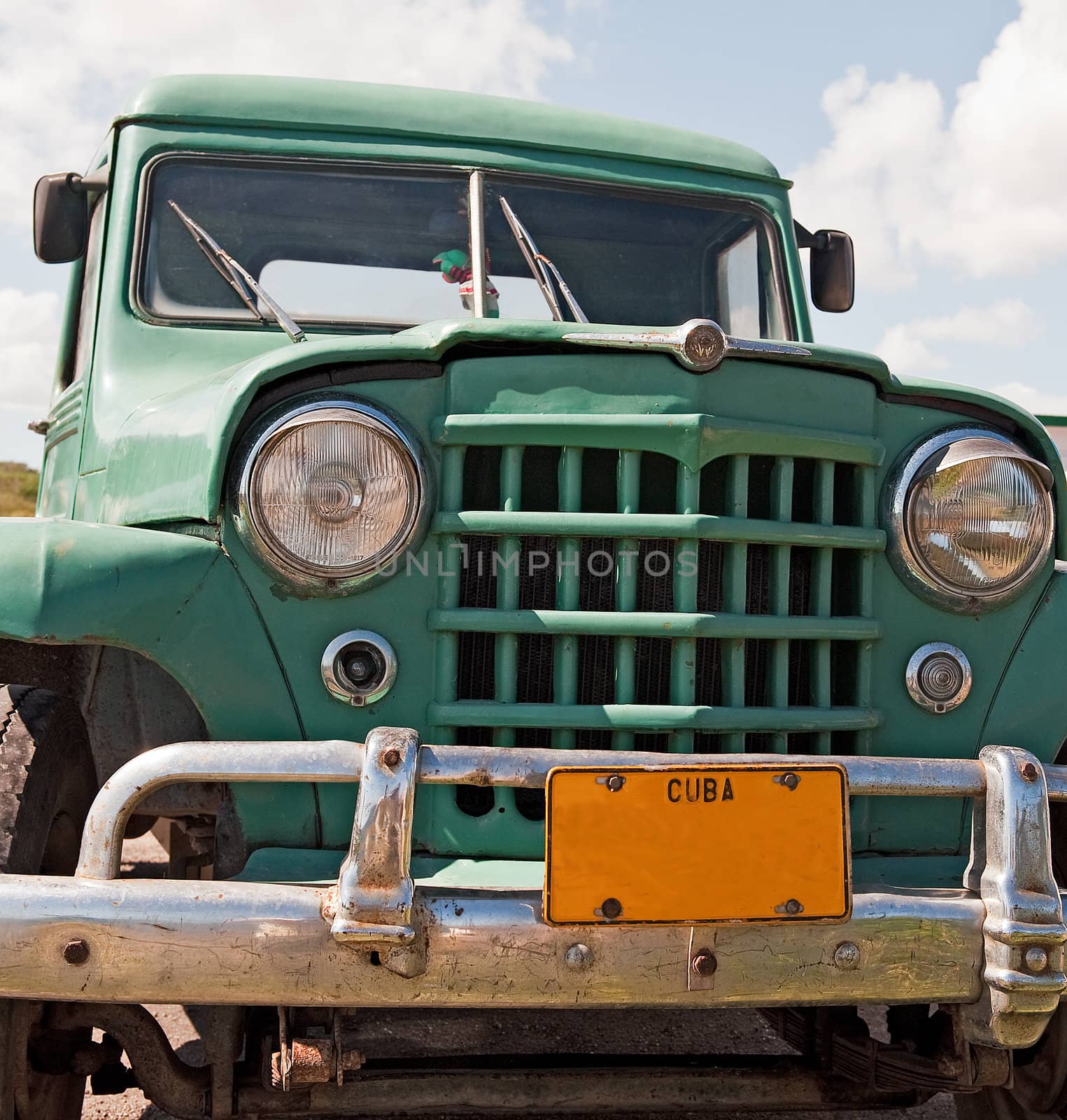Classic green truck front view with cuba licence plate