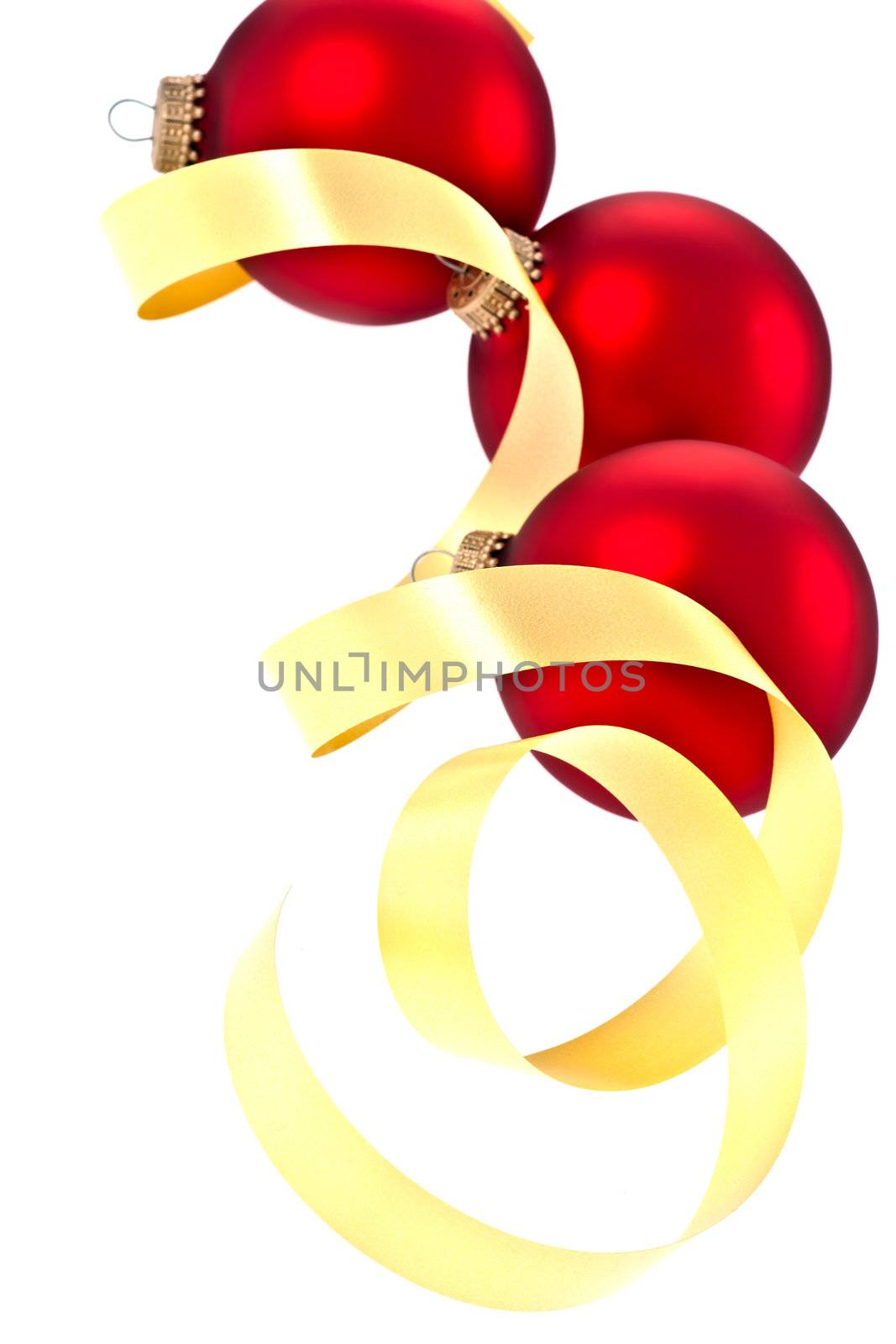 traditional Christmas balls and a yellow curly ribbon isolated on a white background