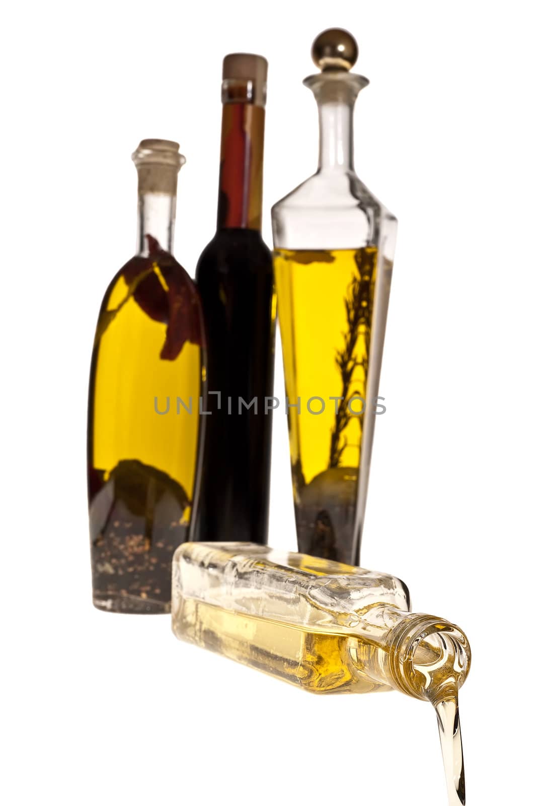 Oil pouring from the bottle image on white background