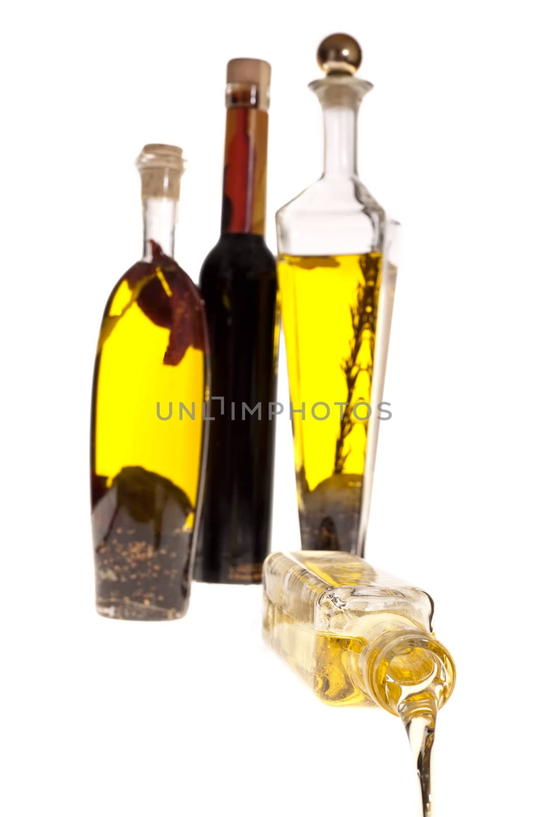 Oil pouring from the bottle image on white background