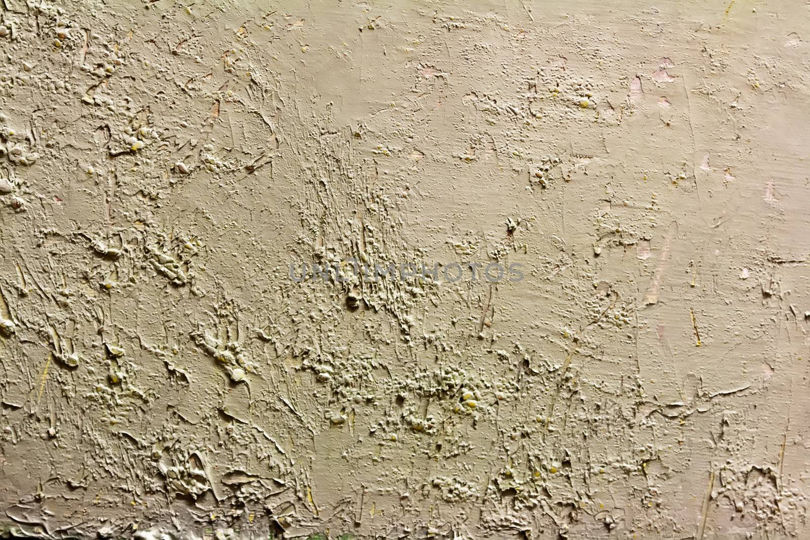 art rough dabs of grey putty on the wall