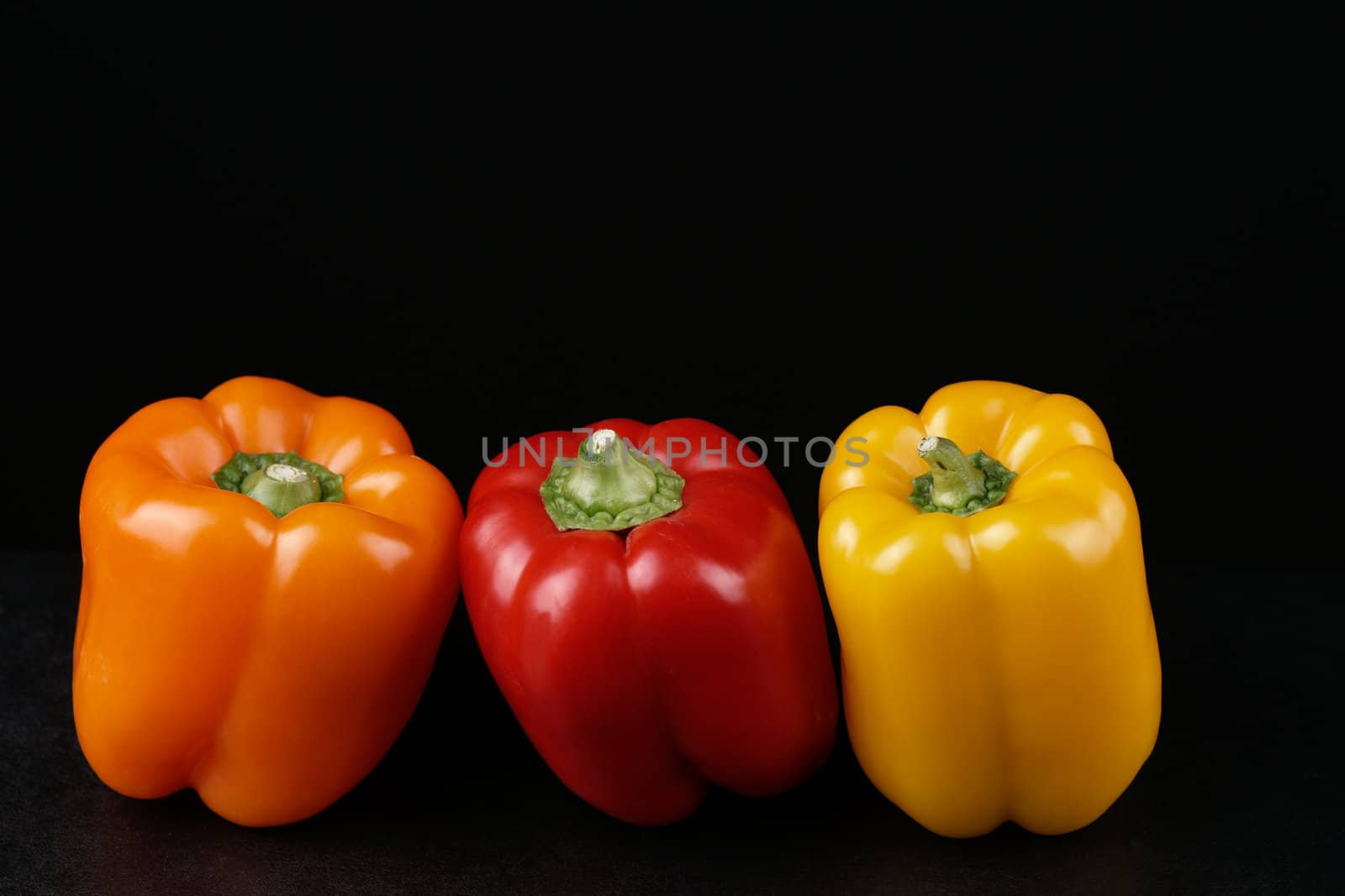 Healthy food samples three fresh peppers red yeyellow and orange