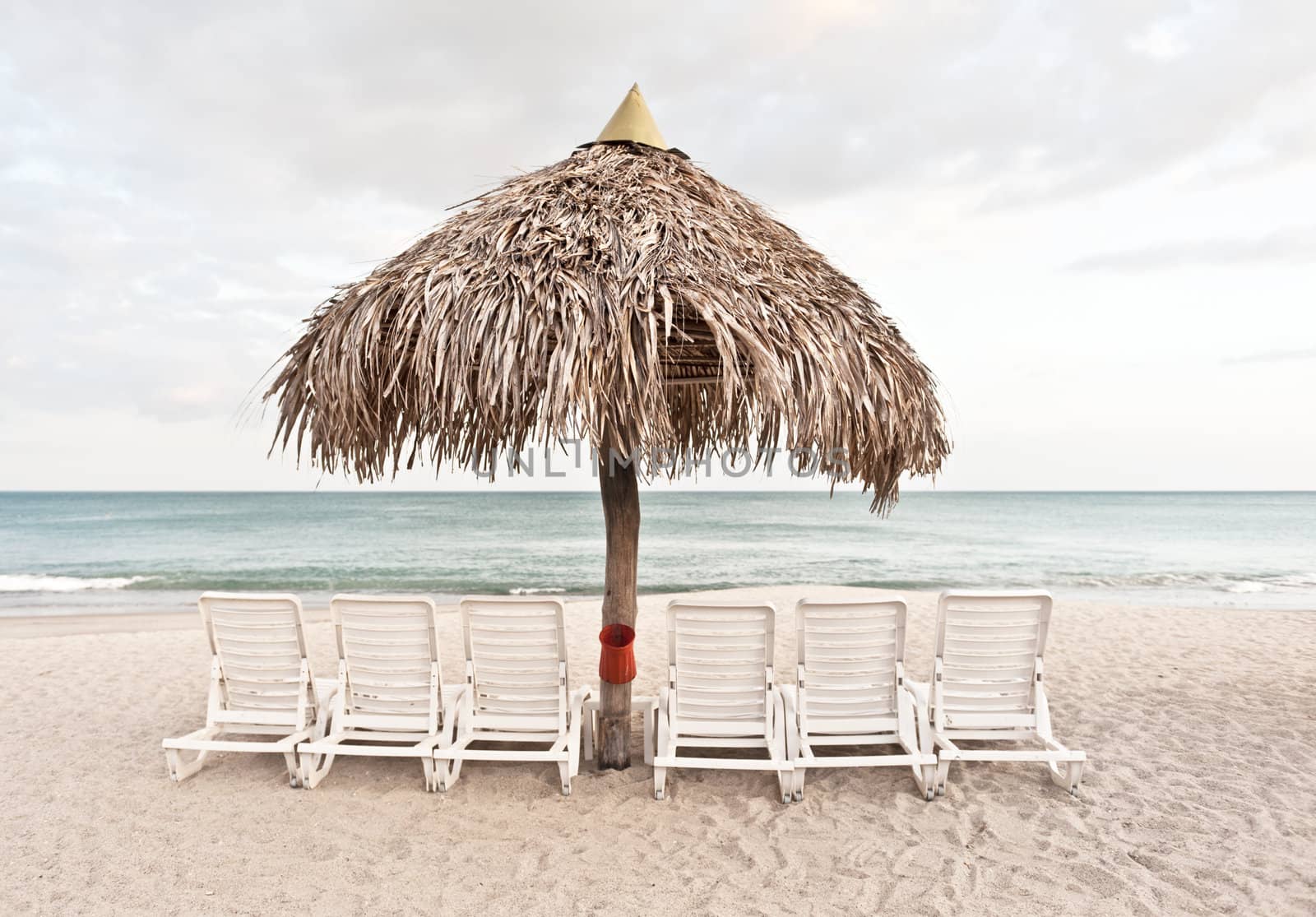 Sandy beach, umbrella and chairs by Marcus