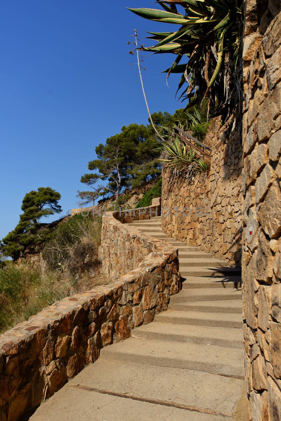 A wall and stairs high above the mediterranean sea