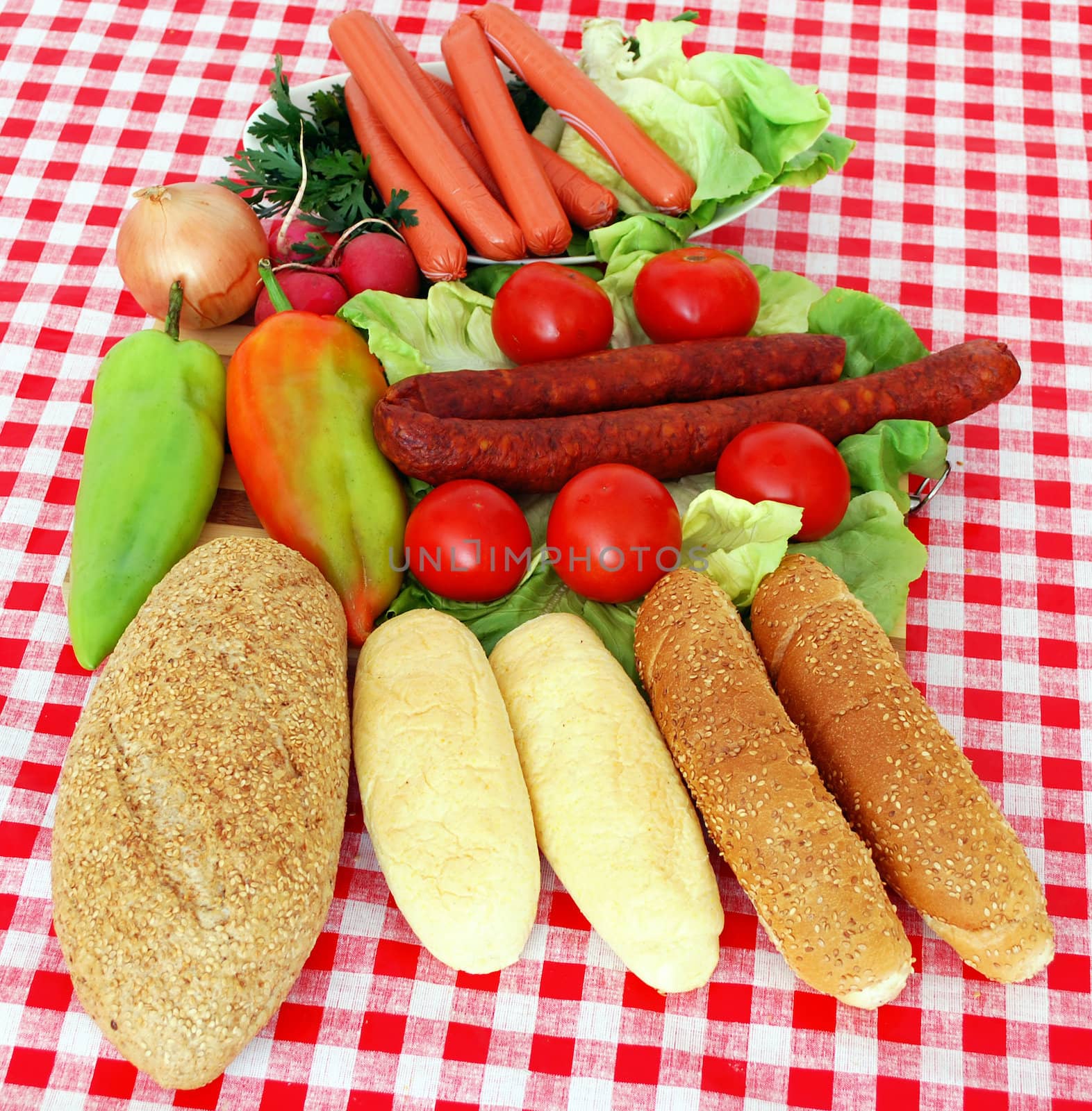 Bread sausage and vegetables on table