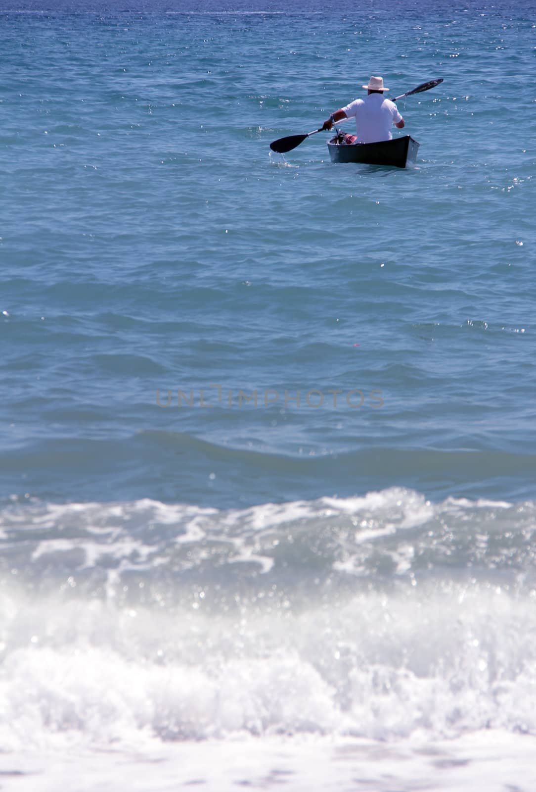 lonely man with rowing boat at the seaside