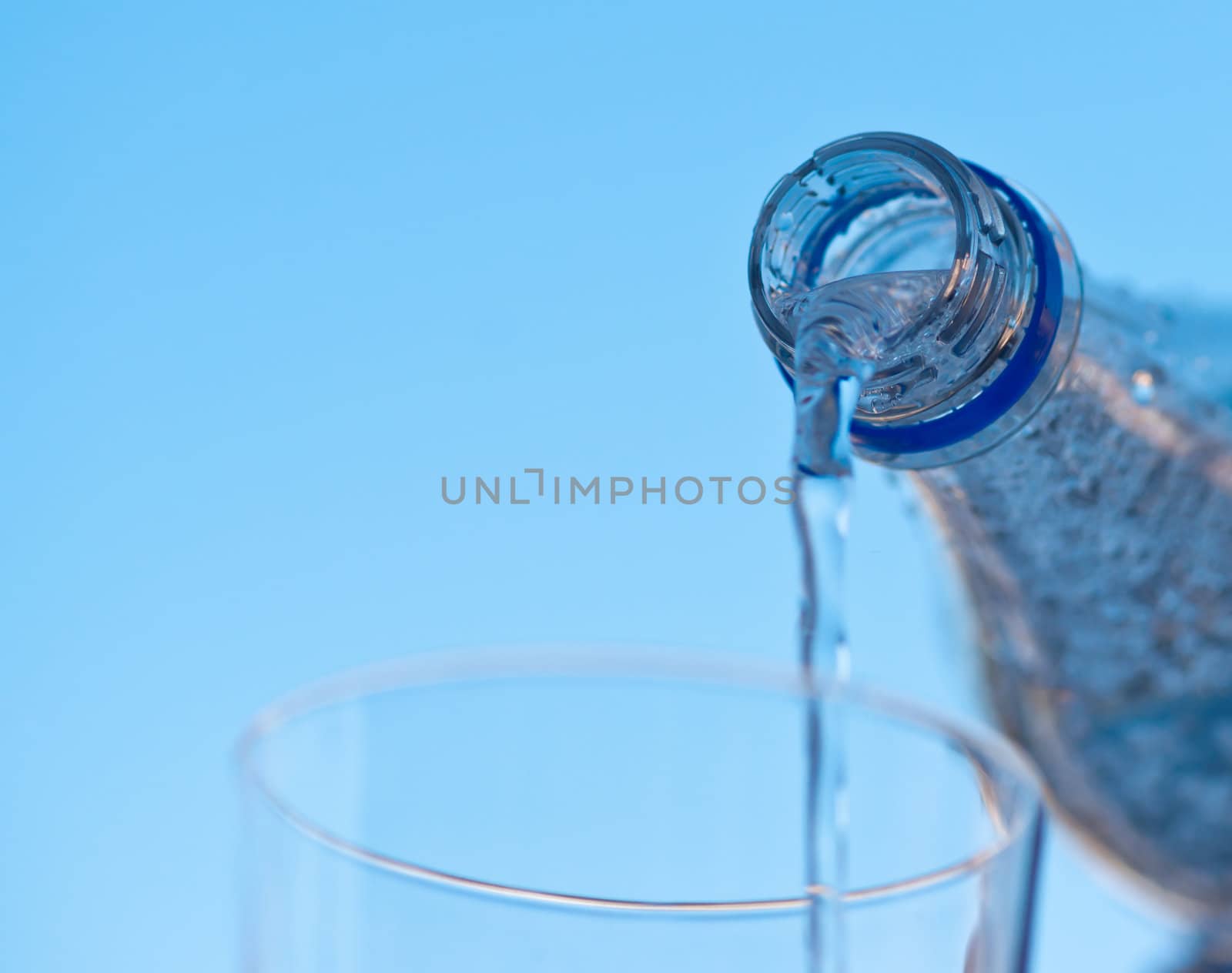 water is pouring down from plastic bottle, image on white background