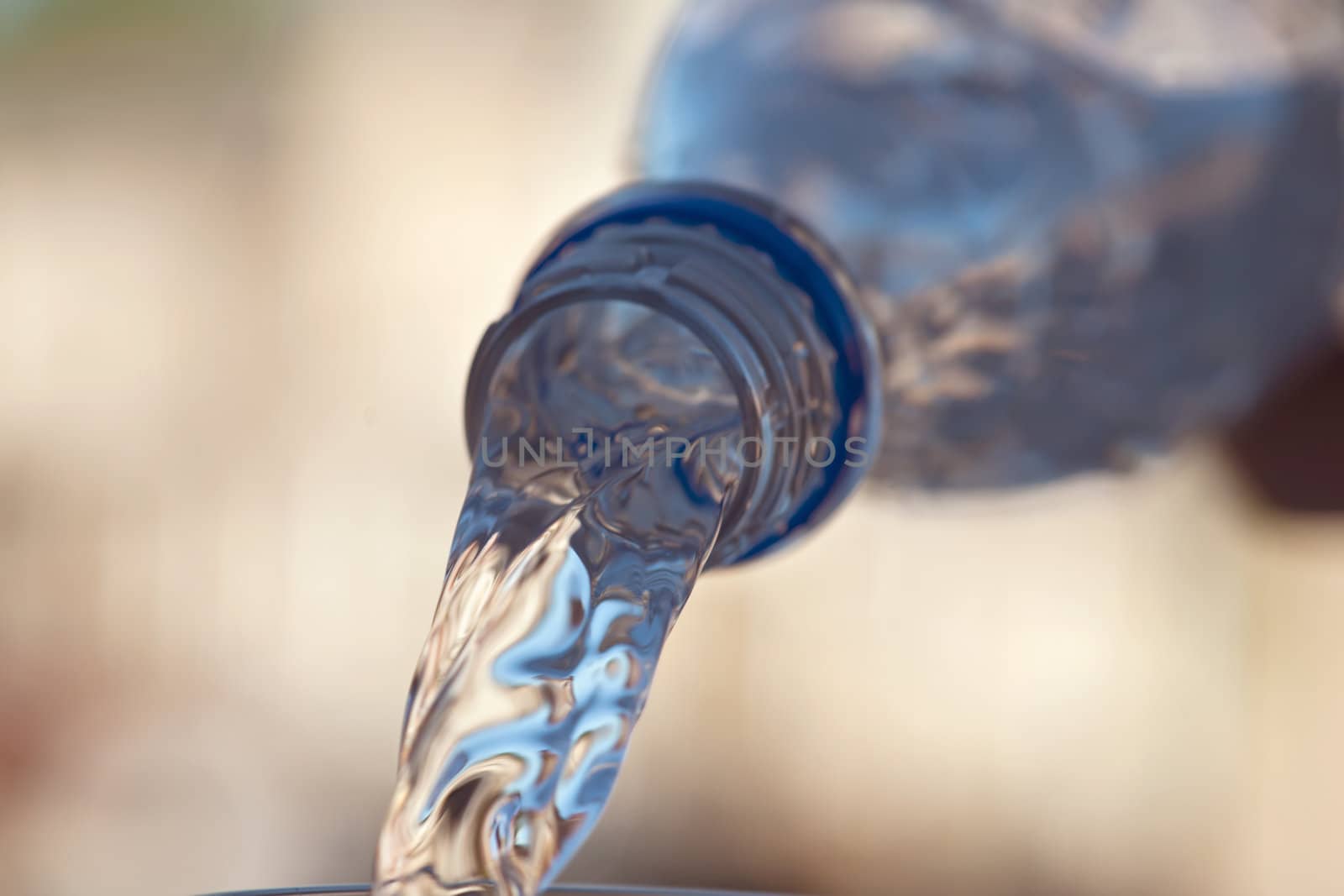 water is pouring down from plastic bottle, image on white background