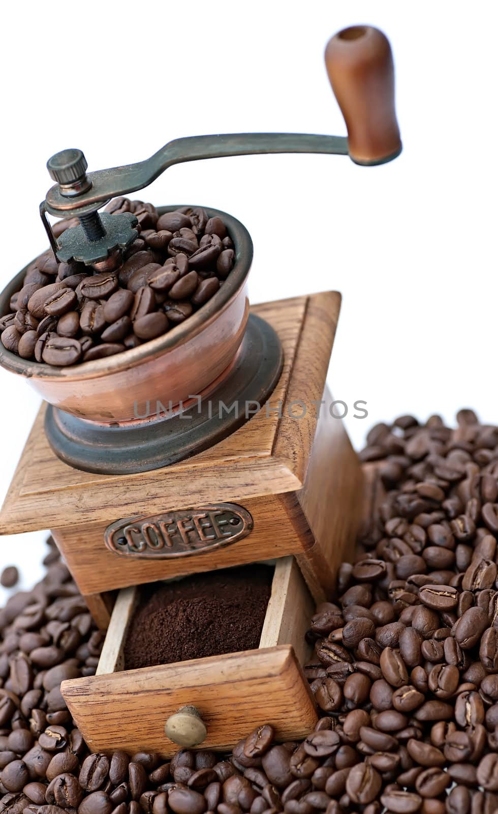 Old coffee grinder with beans