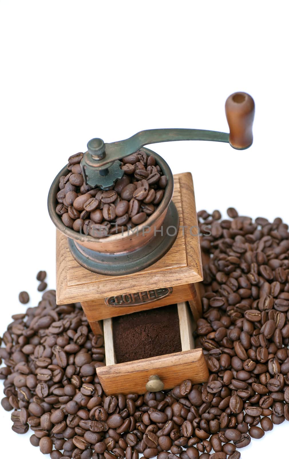 Old coffee grinder with beans