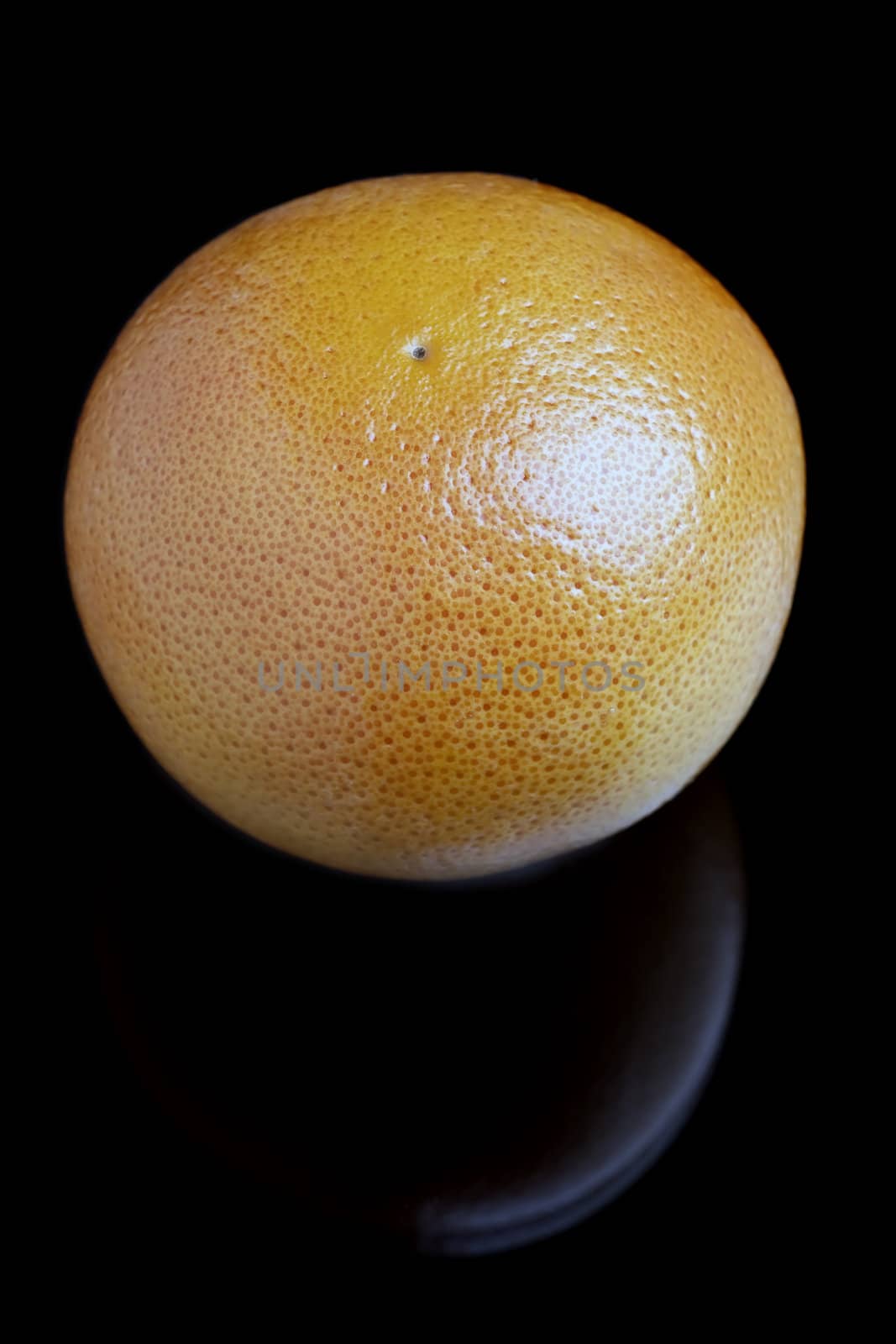 The image of a Fresh grapefruit on black bacground
