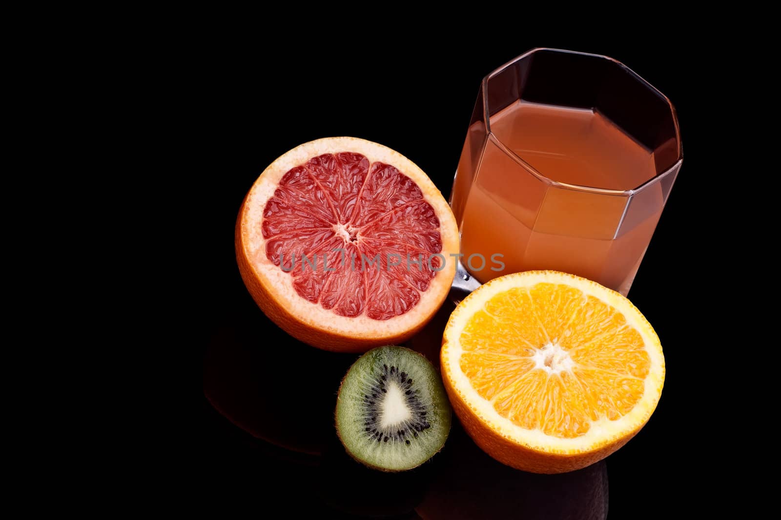 Glass of Grapefruit and orange juice on the black background