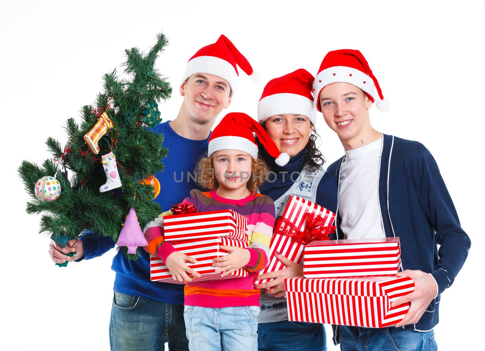 Portrait of friendly family in Santa's hat with gift box and christmas tree, isolated on white