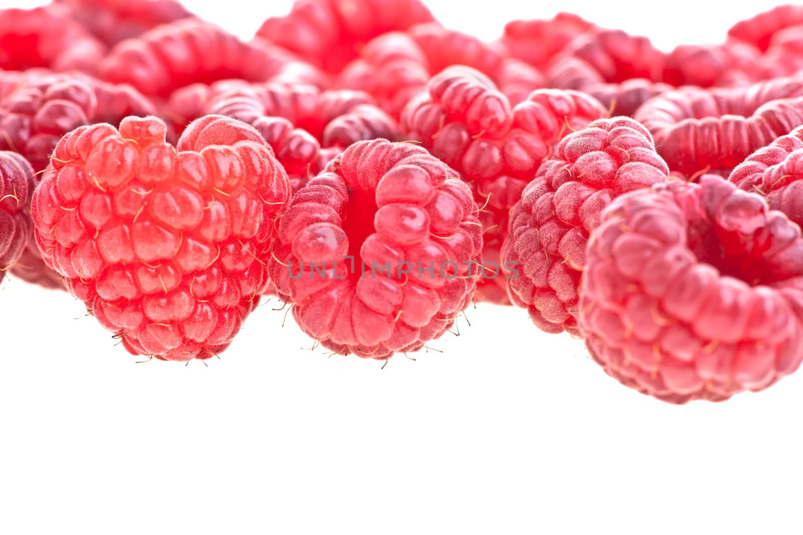 Macro of a stack of raspberries against white background 