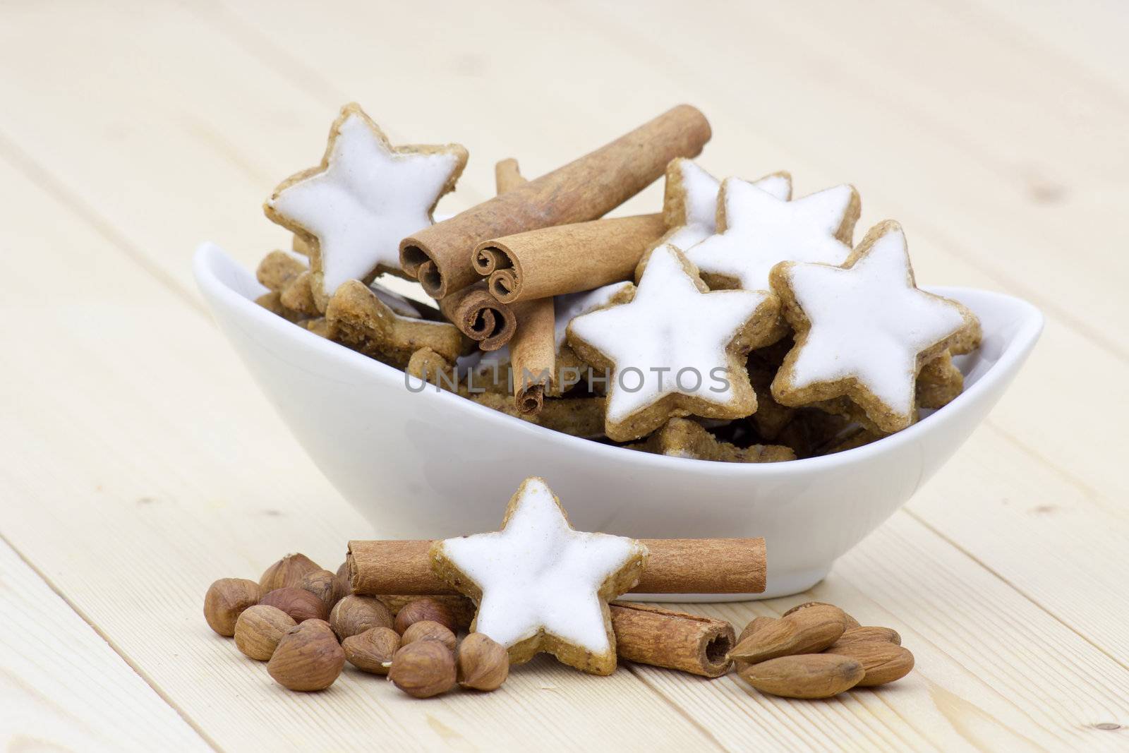 typical christmas cinnamon star cookies, nuts and cinnamon sticks