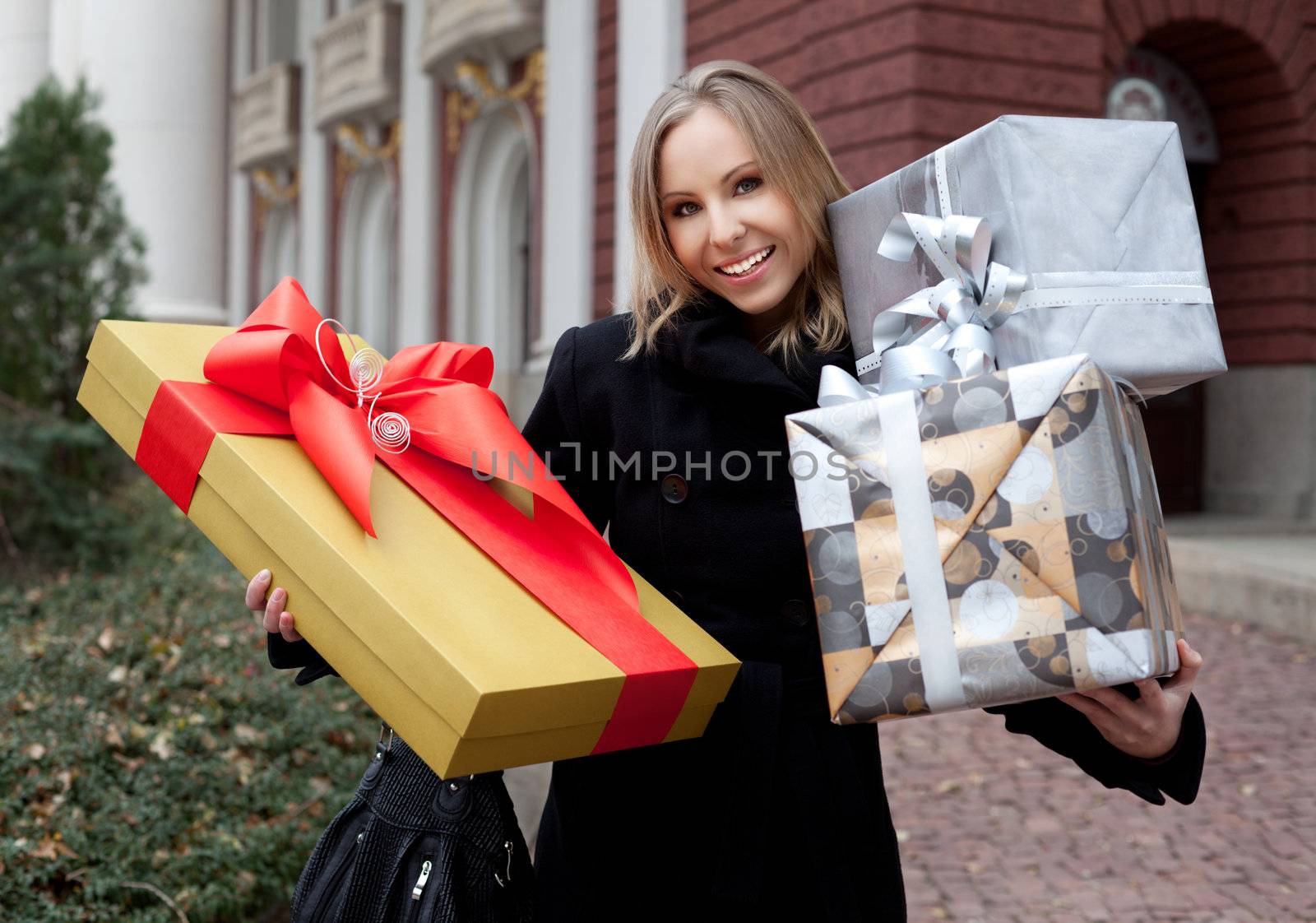 Woman holding gifts by vilevi