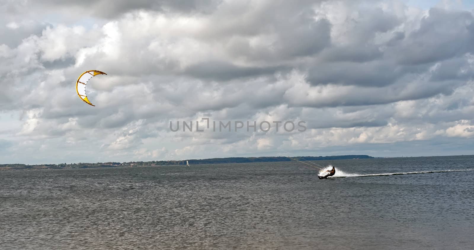 Kite surfing on a cloudy day in Baltic sea