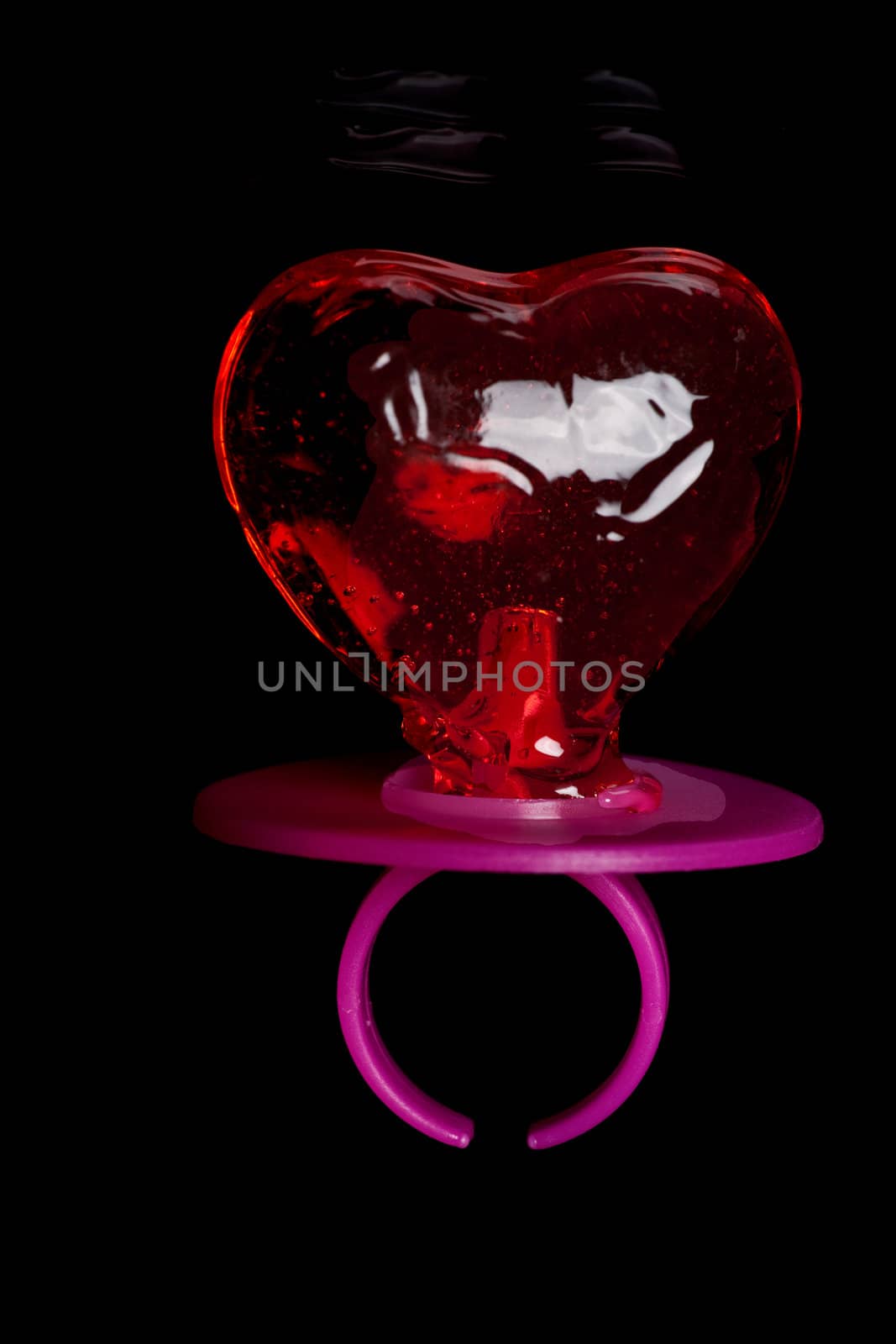 Baby teat in heart shape on black background