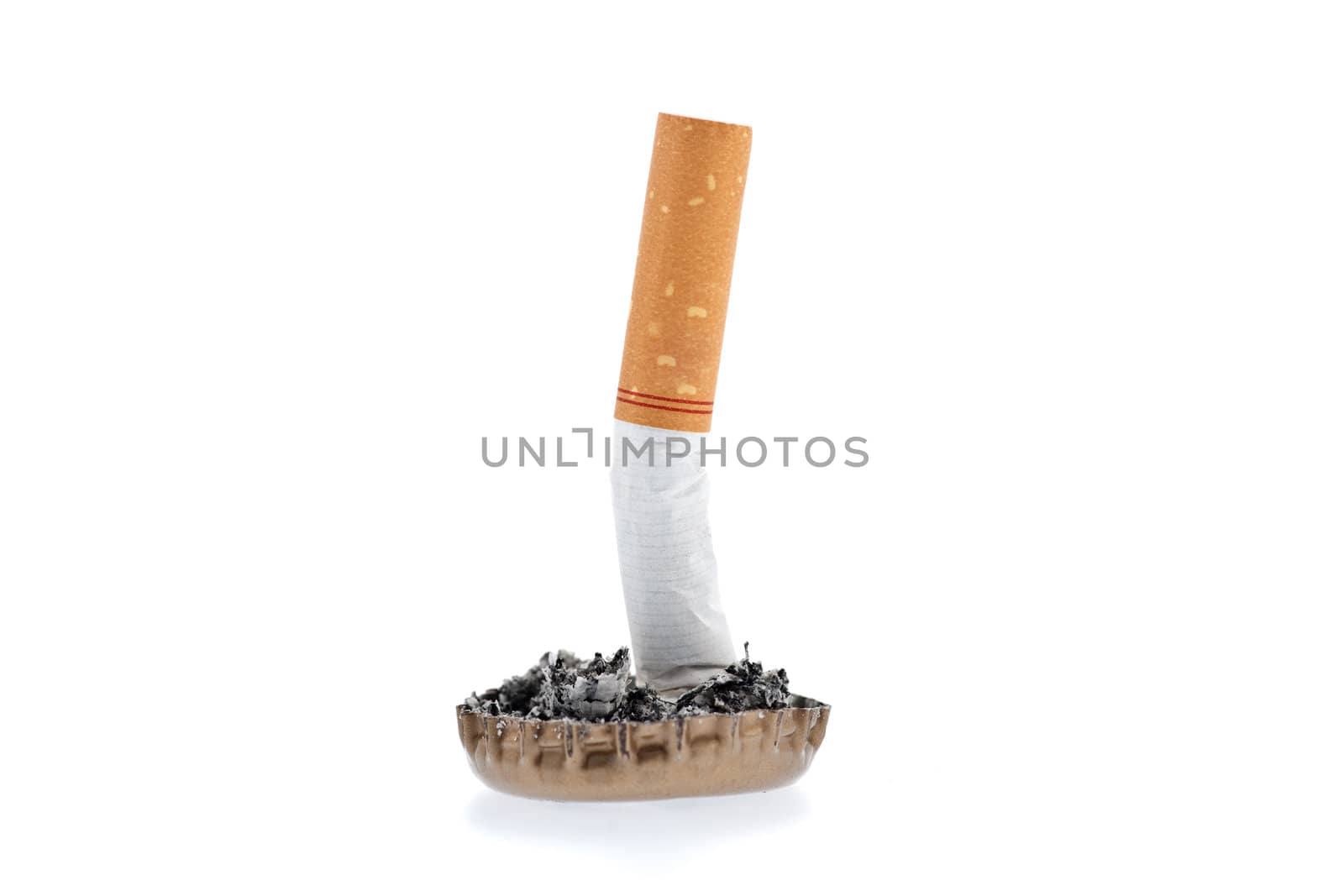 Quit smoking, cigarette butt in a bottle cap on white background