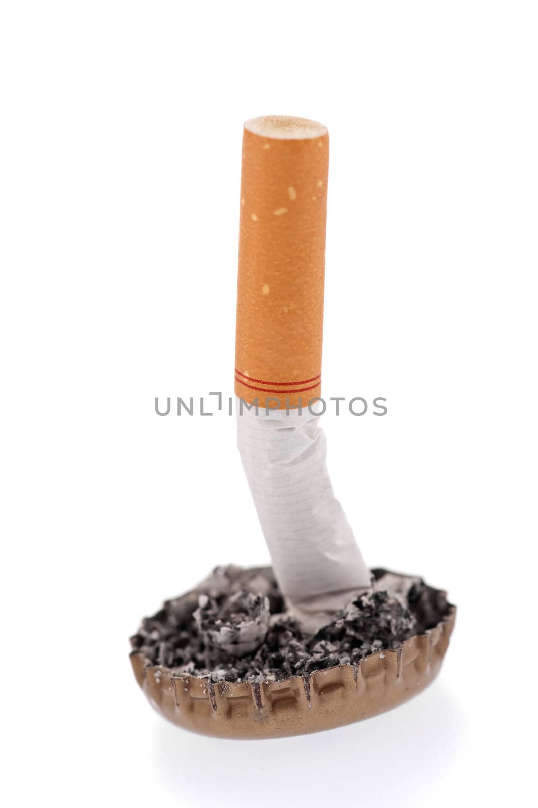 Quit smoking, cigarette butt in a bottle cap on white background