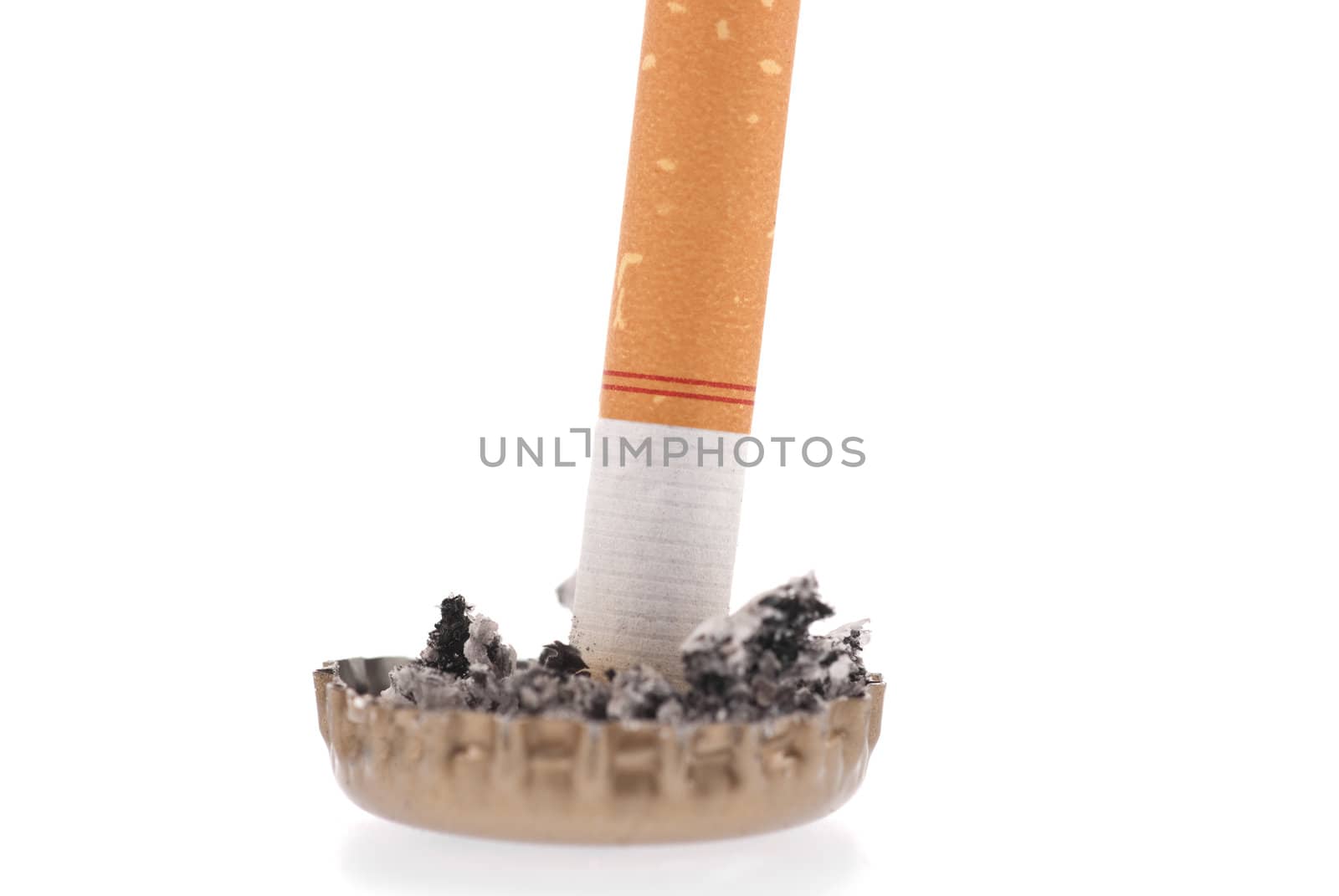 Quit smoking, cigarette butt in a bottle cap on white background