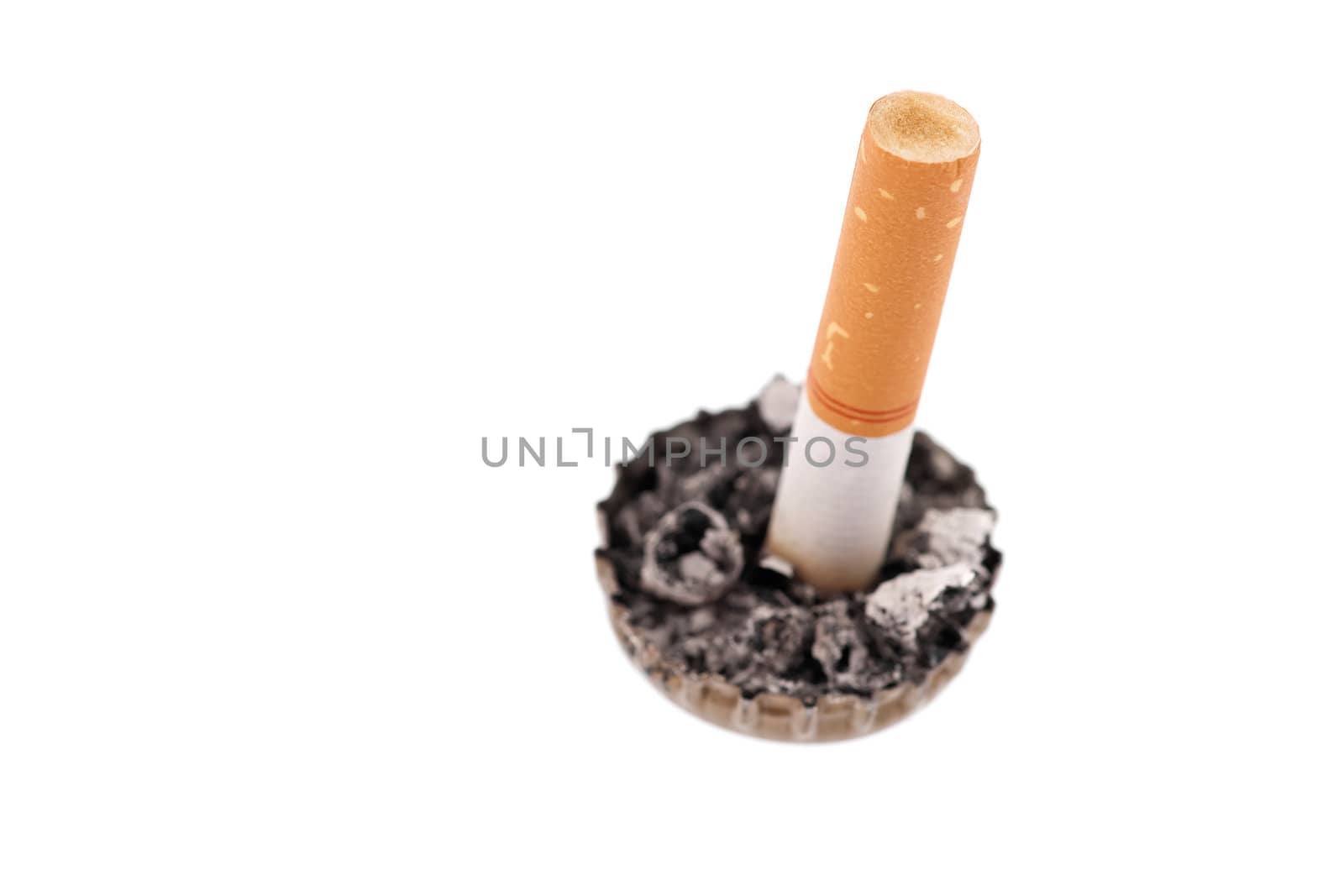 cigarette butt in a bottle cap on white background by Marcus