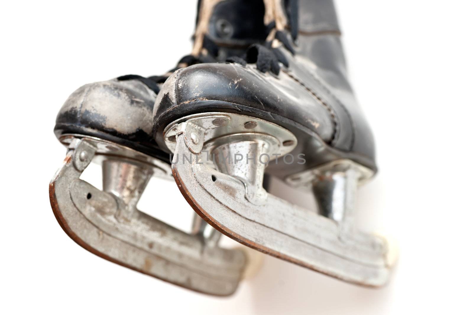 Old hockey skates hanging on the wall