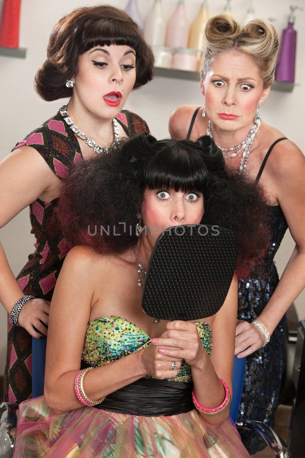 Shocked woman behind mirror with curious ladies in hair salon